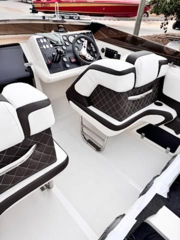 1992 Fountain Fever boat interior with black and white seating and control panel.