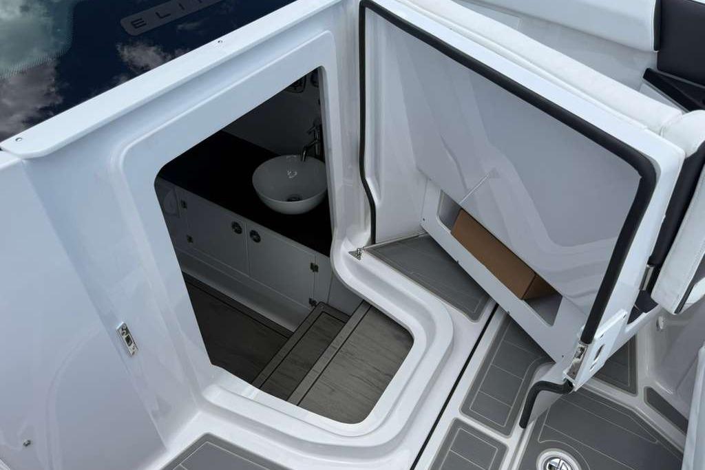Interior view of 2026 Monterey Elite 30 OB boat, featuring a compact sink and modern design.