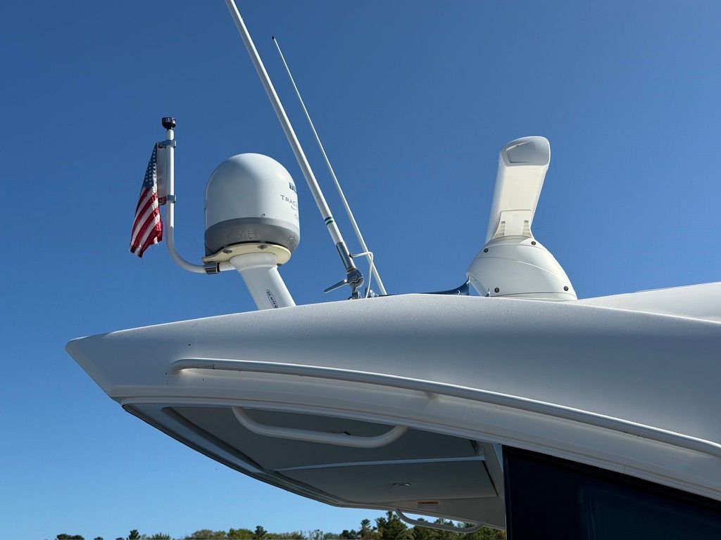 Close-up of a Tiara Yachts C44 Coupe roof with antennas and a US flag.