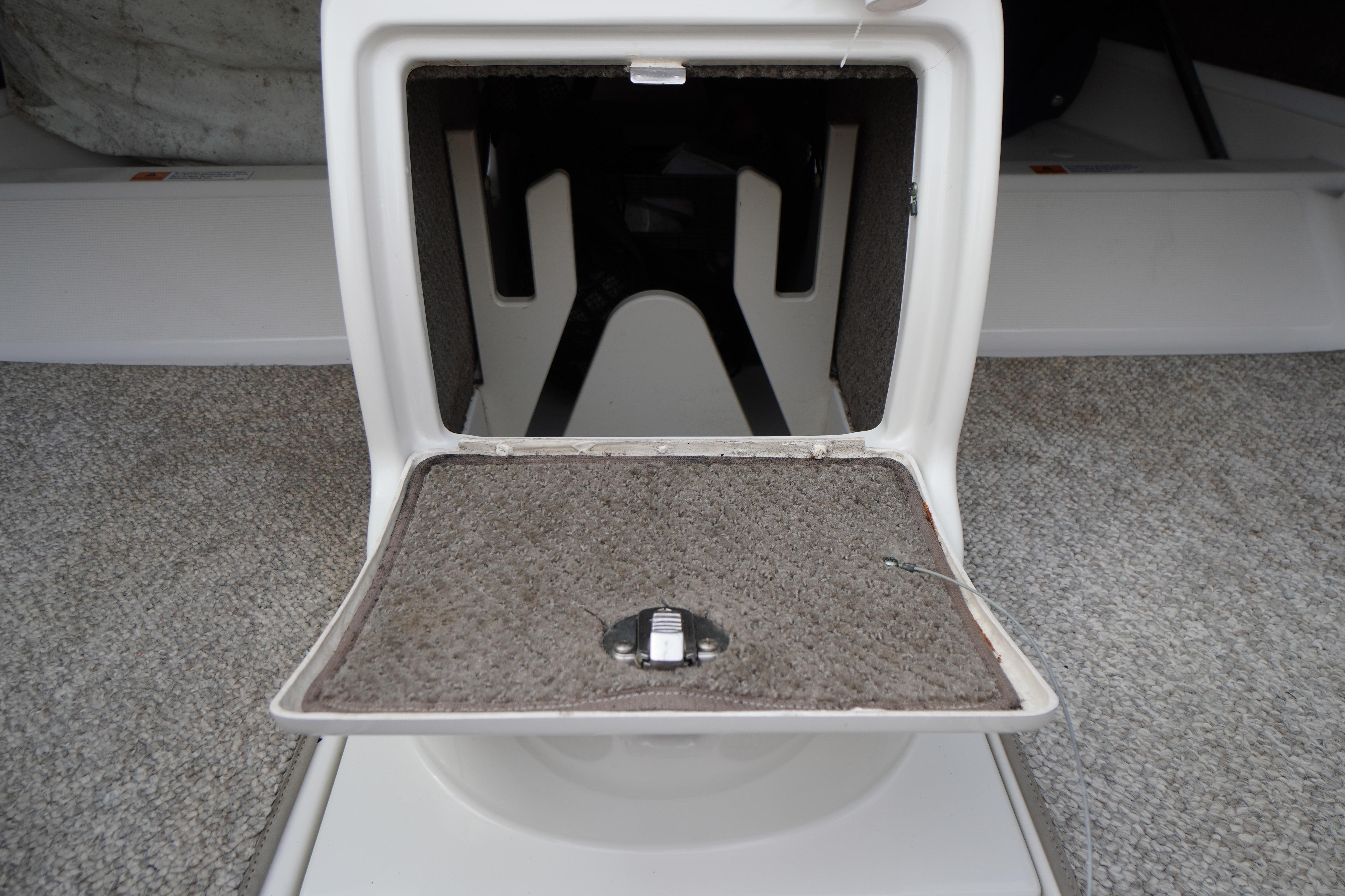 Storage compartment in a 2005 Chris Craft Speedster Heritage boat, featuring carpeted interior.