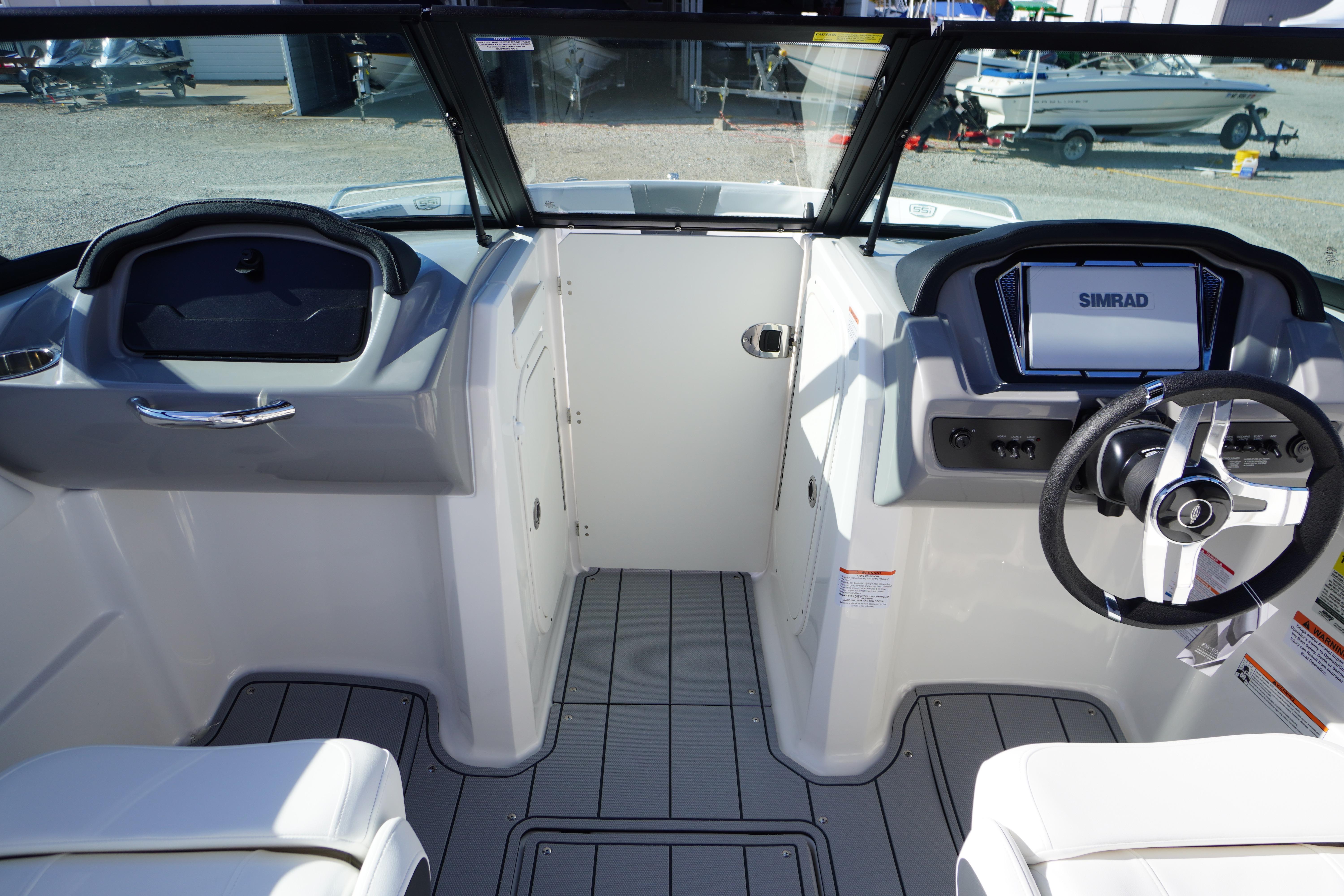 Interior view of 2026 Chaparral 23 SSi OB boat, featuring modern dashboard and steering wheel.