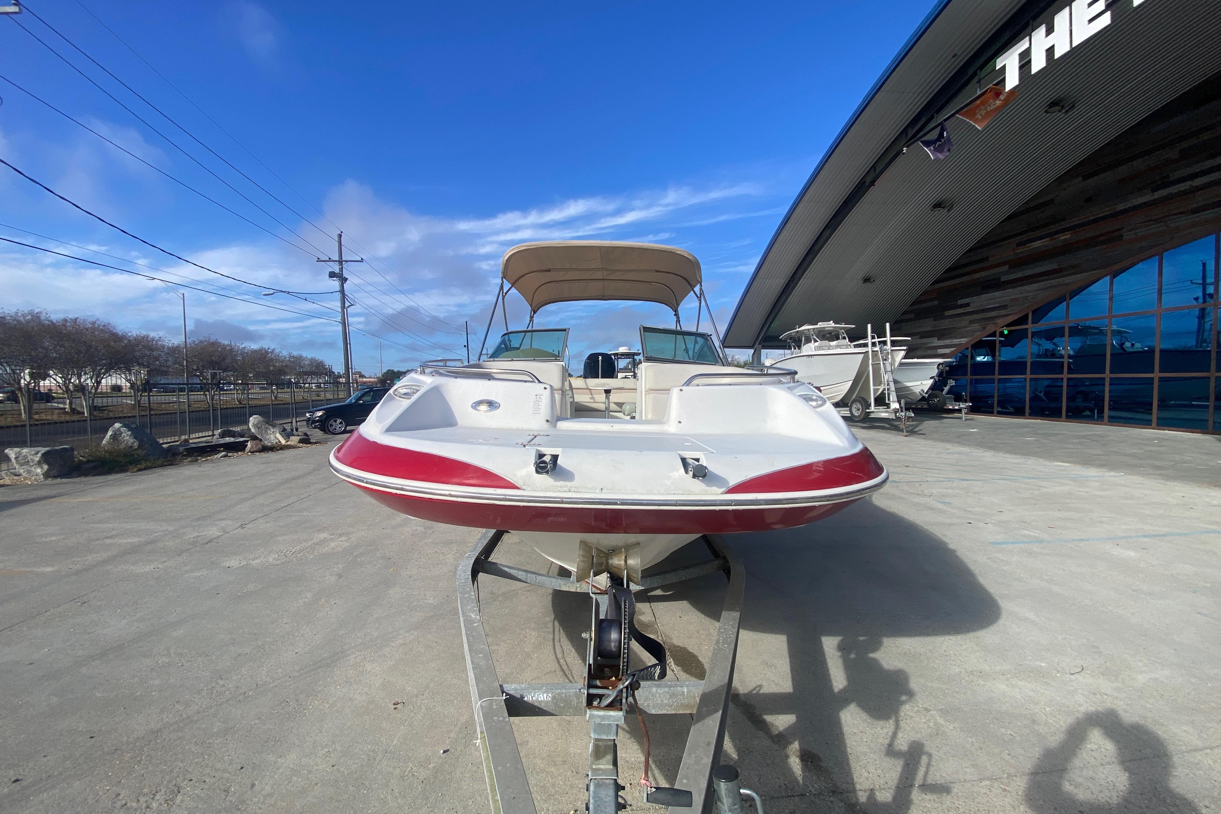 2007 NauticStar 230DC Sport Deck boat on trailer, outdoor showroom display.