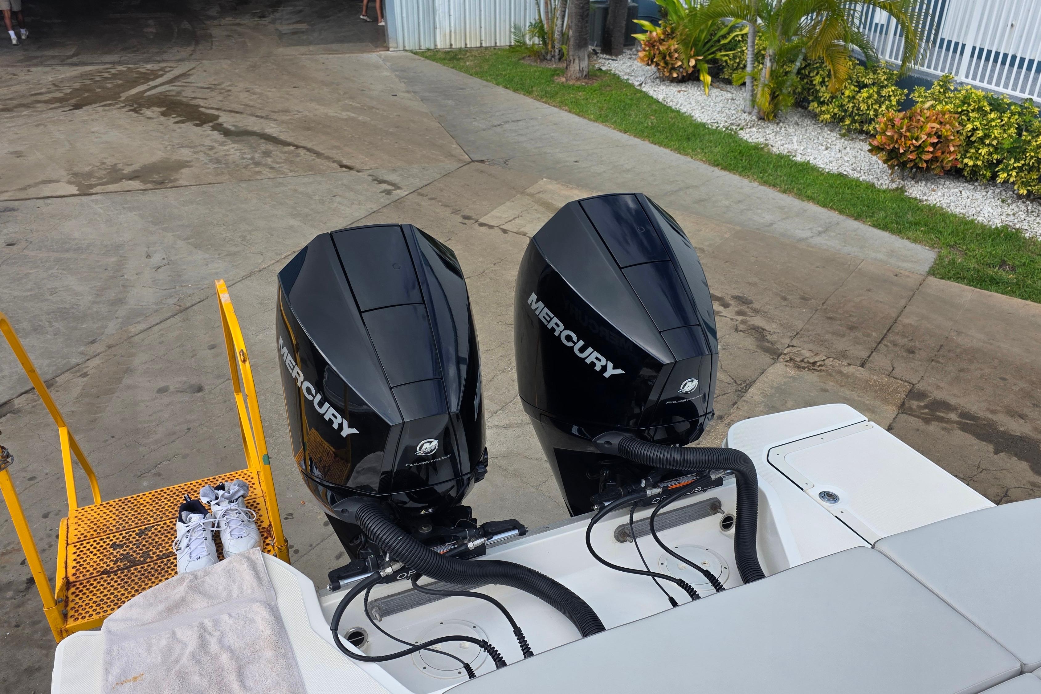 2021 Sea Ray SDX 290 Outboard with dual Mercury engines, docked near greenery.