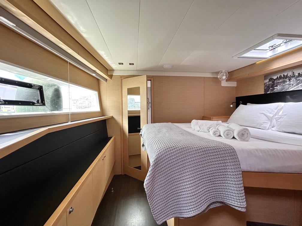 Luxurious cabin interior of 2013 Lagoon 52 yacht with cozy bed and modern design.