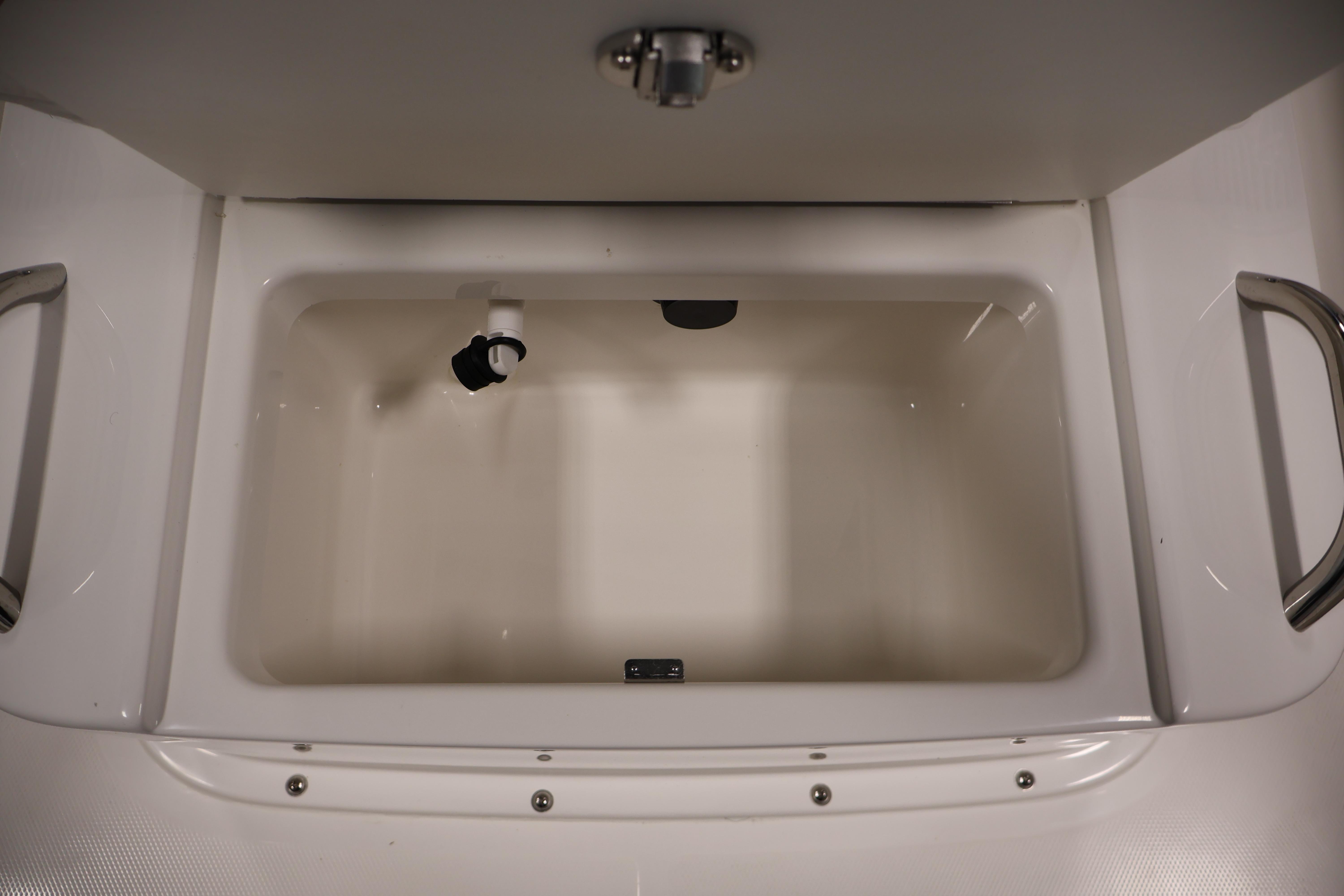 Livewell compartment in 2026 Bayliner Trophy T18 boat, featuring stainless steel handles.