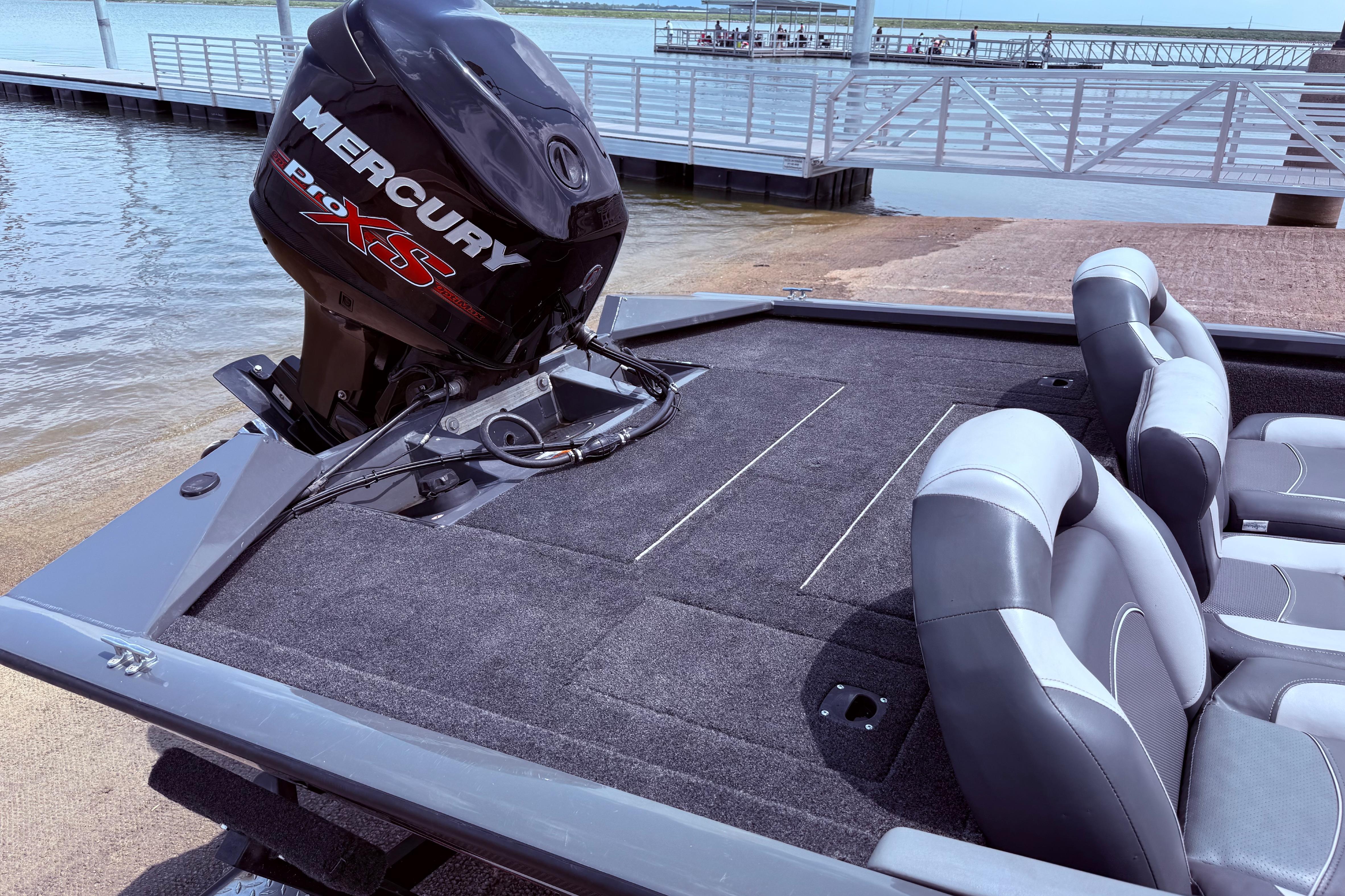 2015 Tracker Pro Team 190 TX boat with Mercury engine, docked by the water.