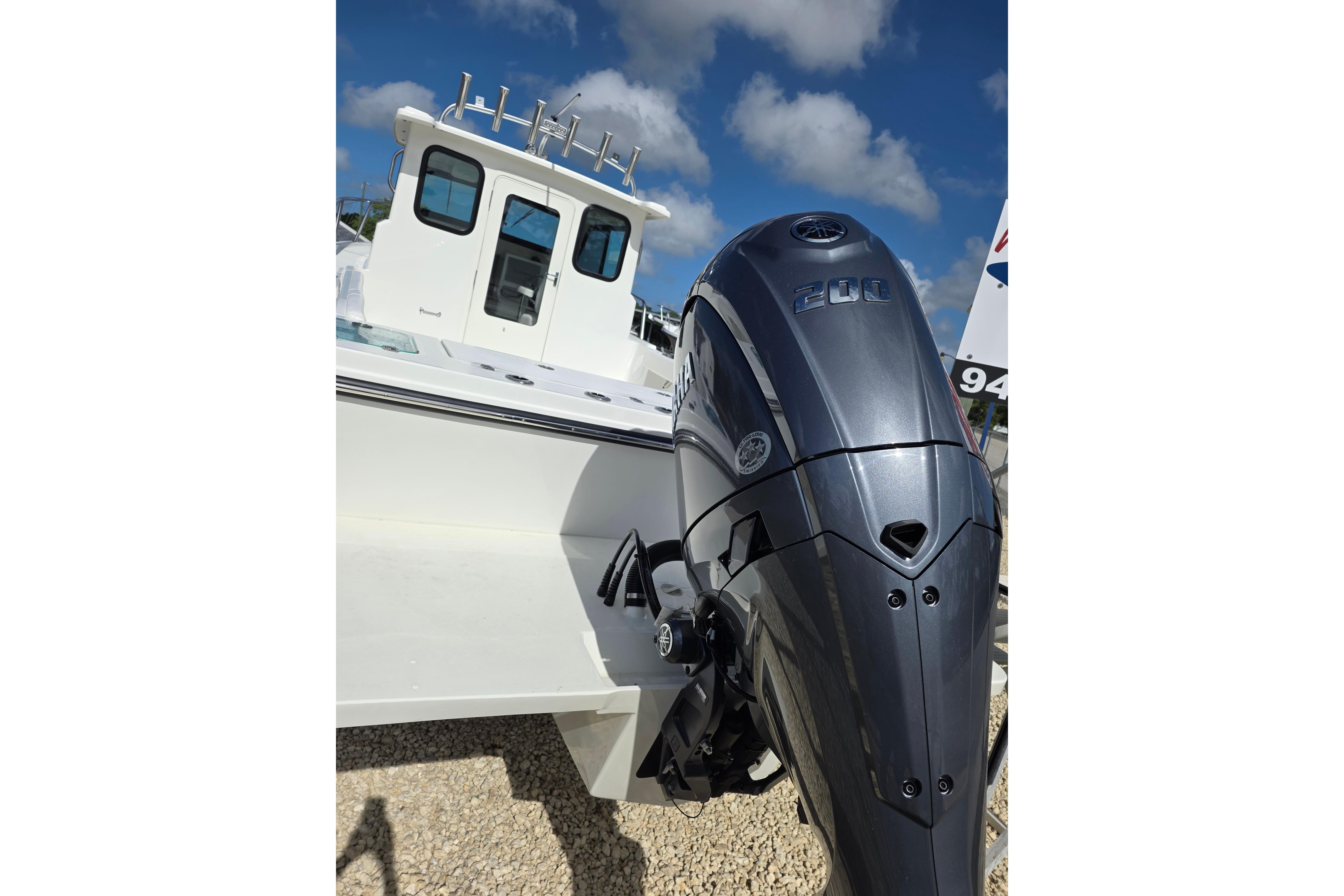 2026 Parker 227 Explorer boat with powerful outboard motor under a clear blue sky.