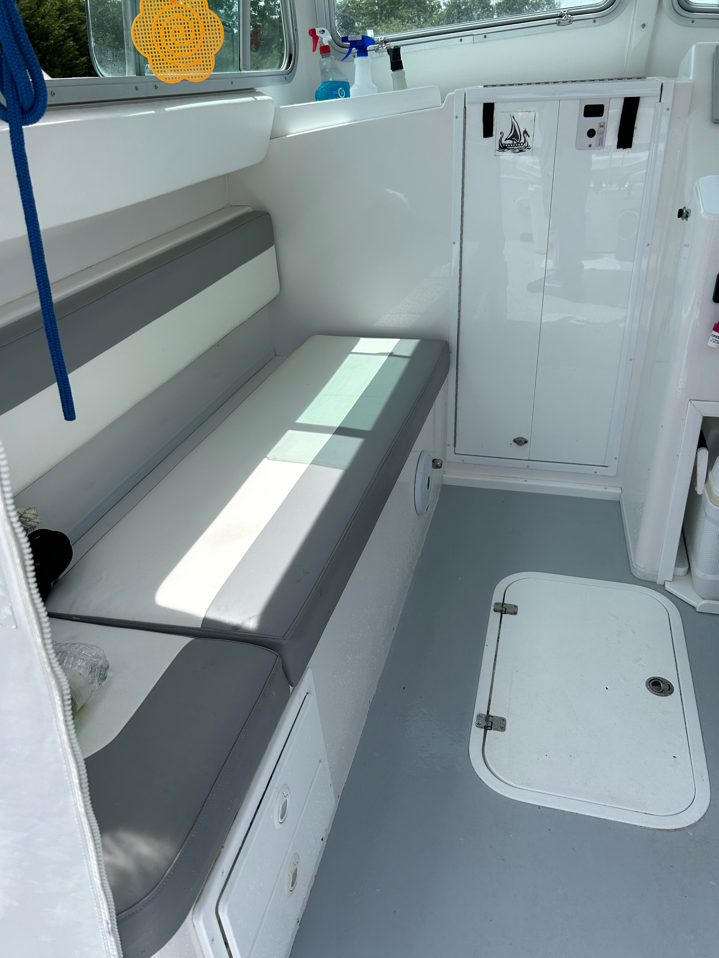 Interior of a 2019 Steiger Craft 28 Miami boat with gray and white seating.