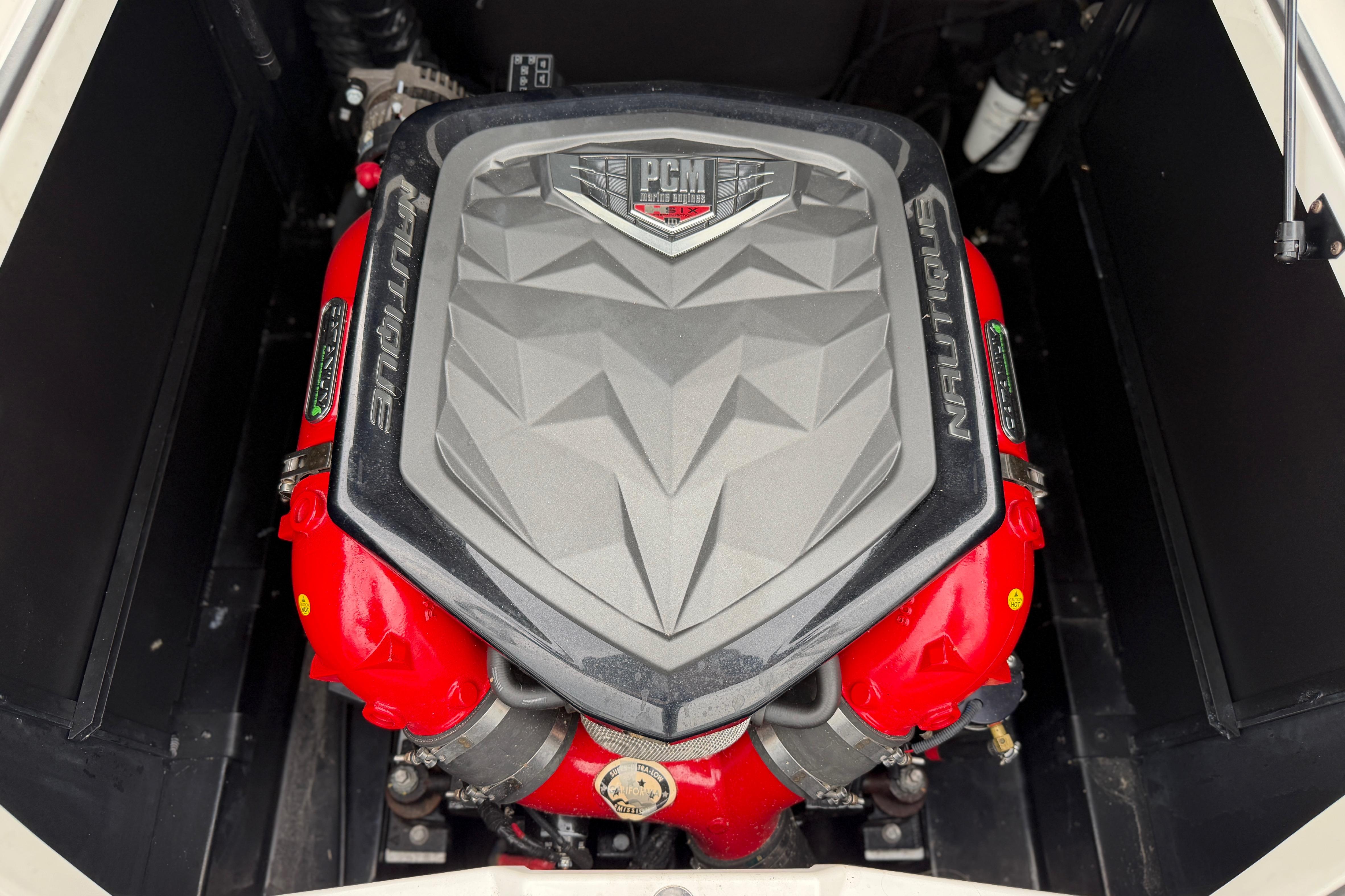 2016 Naitique G25 engine with PCM cover, featuring red components and Nautique branding.