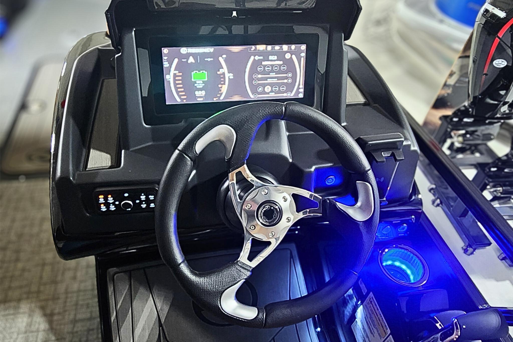 Steering console of 2026 Regency 250 DL boat with digital display and controls.