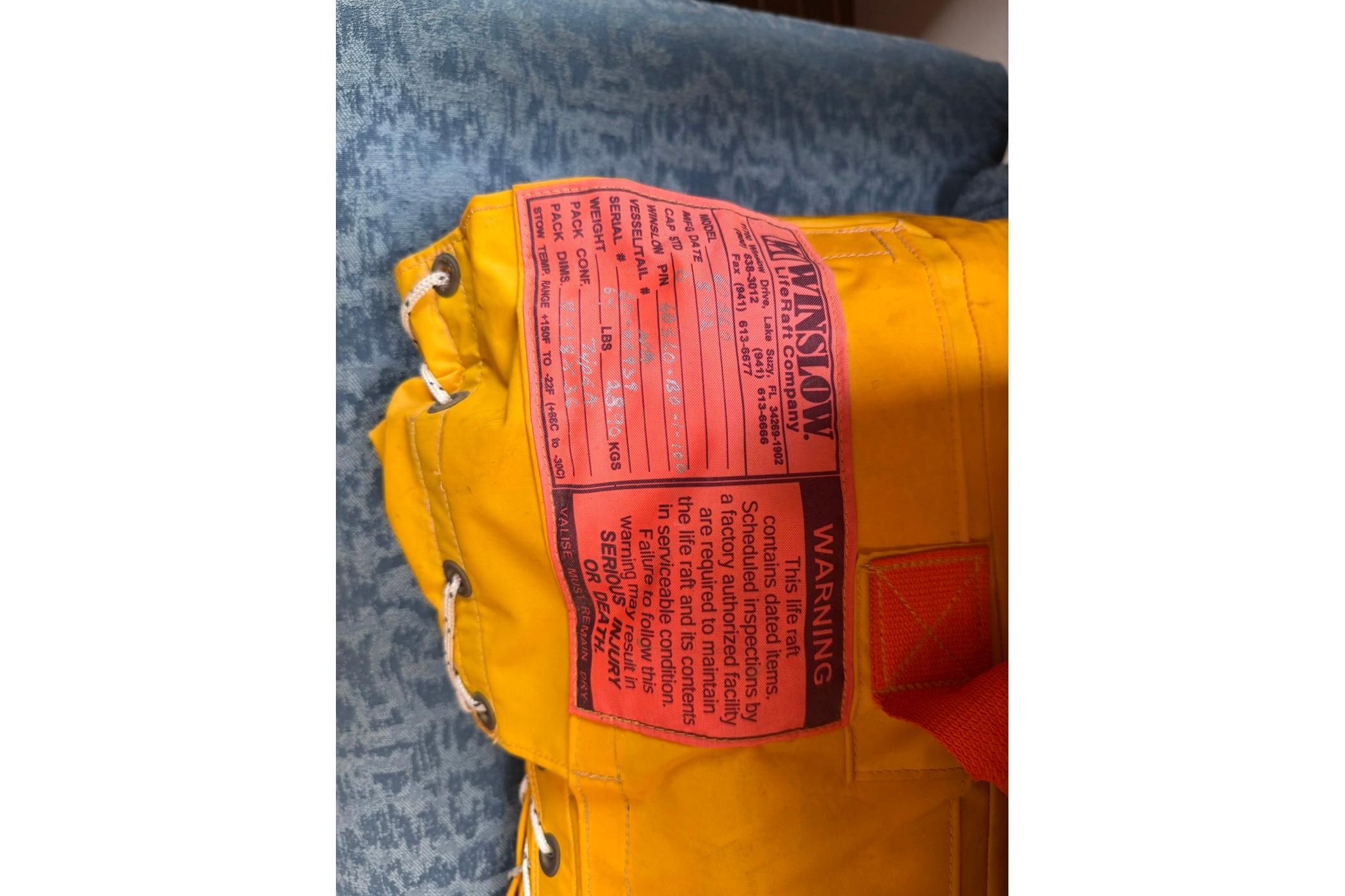 Yellow Winslow life raft with warning label, Hunter 410 model, 1998.