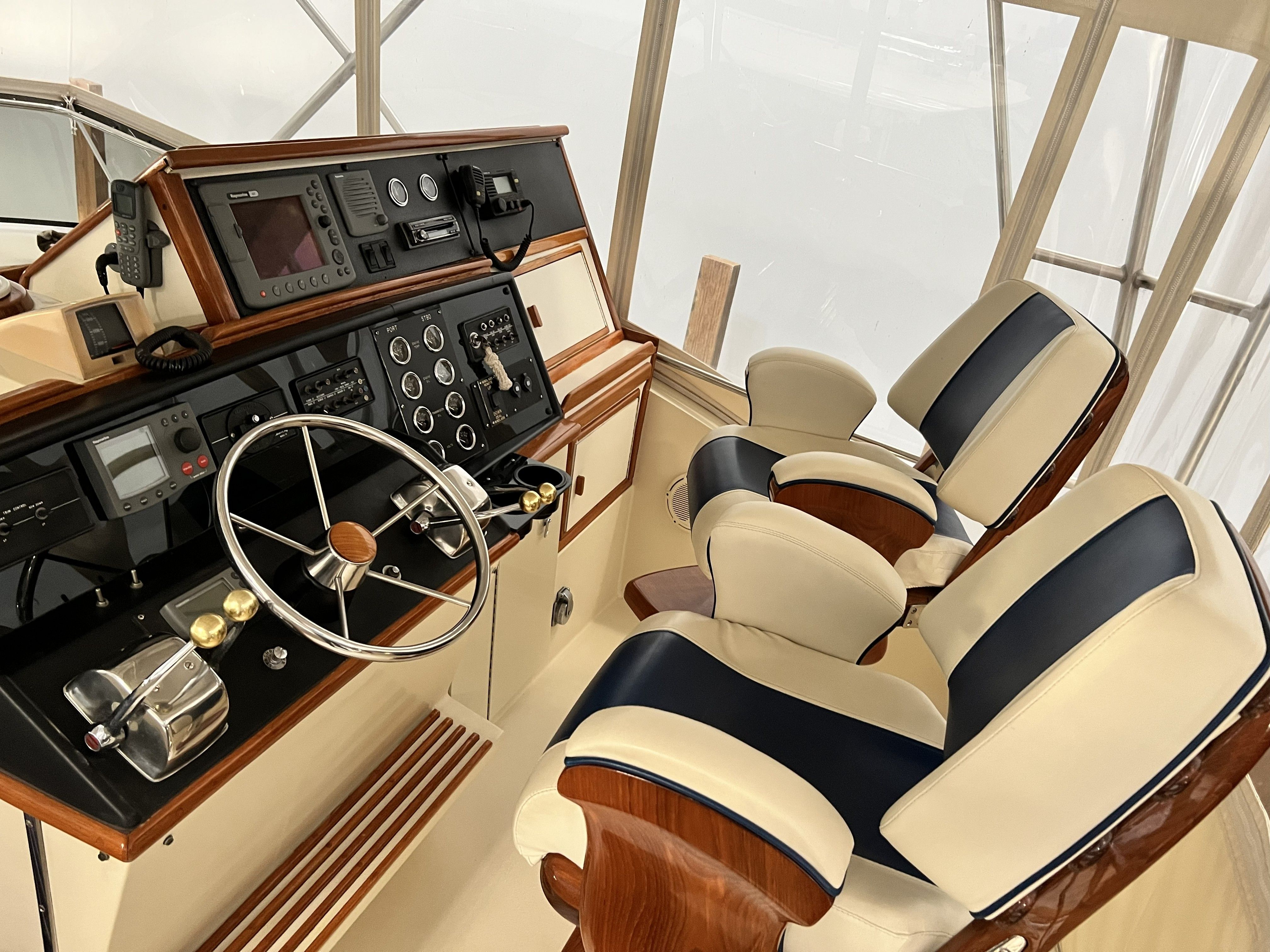 The image shows the cockpit of a 1979 Chris-Craft 45 TF with elegant seats and instruments.