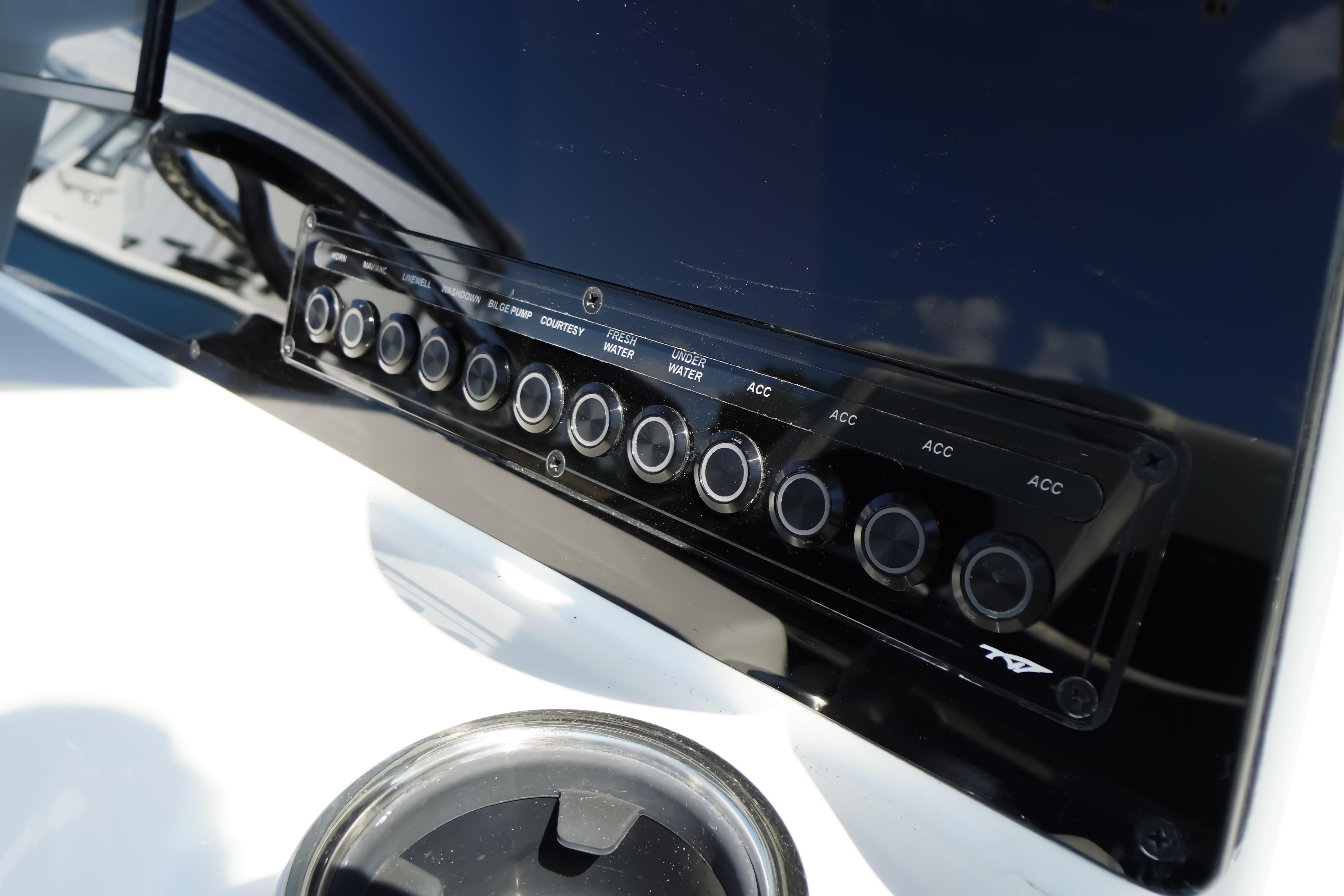 Control panel of 2026 Tidewater 220 CC Adventure boat with multiple switches.