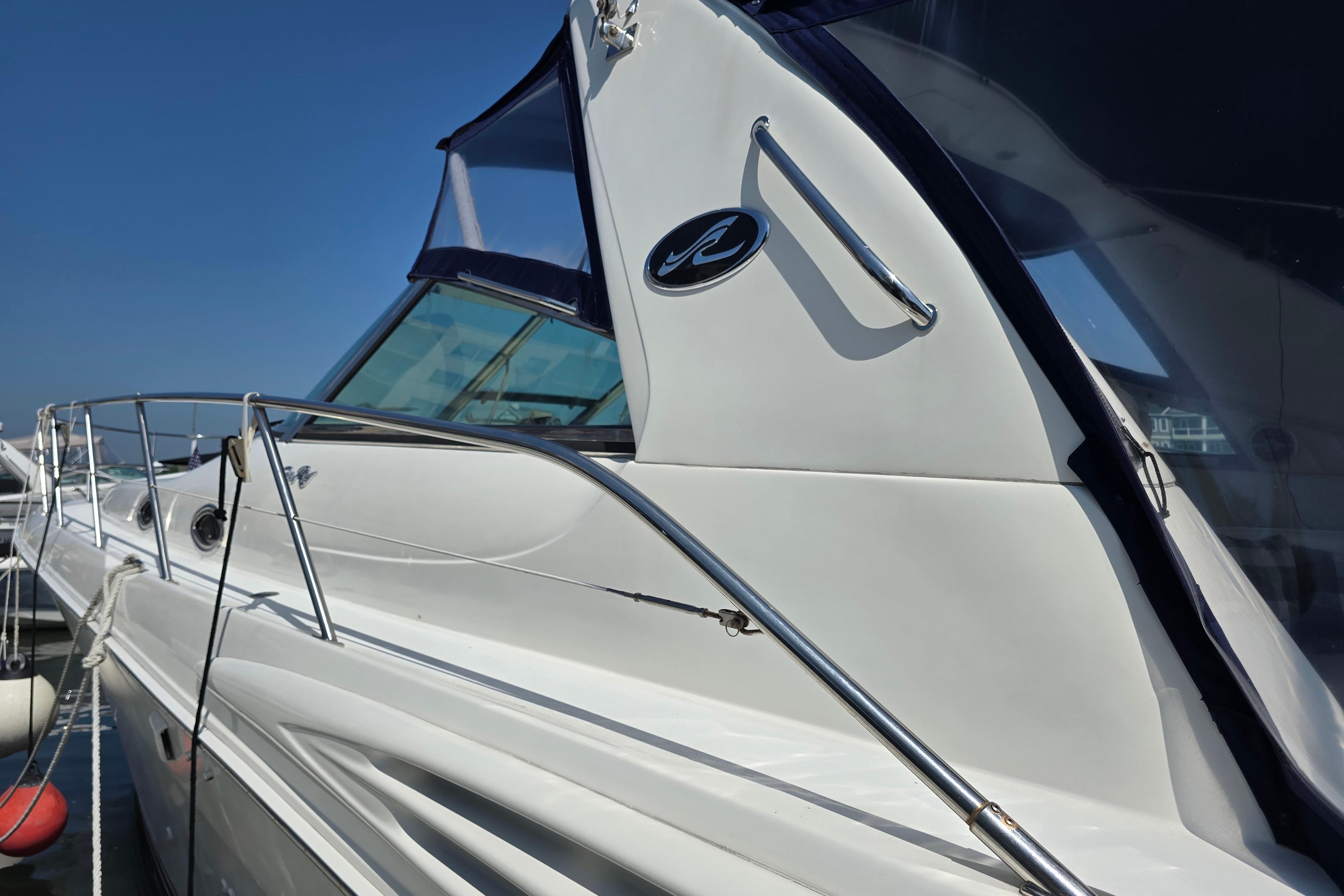 1999 Sea Ray Sundancer 400 yacht docked, showcasing sleek design and polished exterior.
