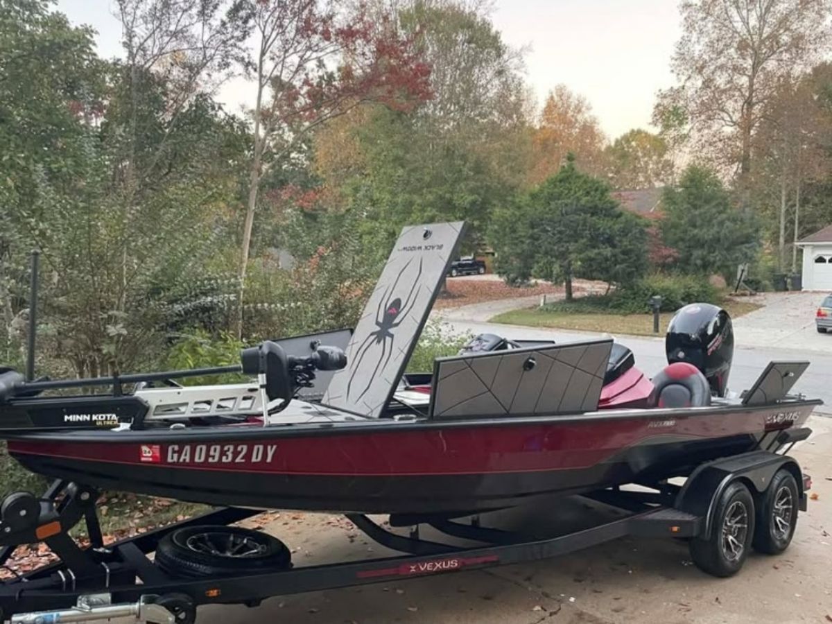 A 2021 Vexus AVX1980 BLACK WIDOW boat on a trailer in an autumn setting.