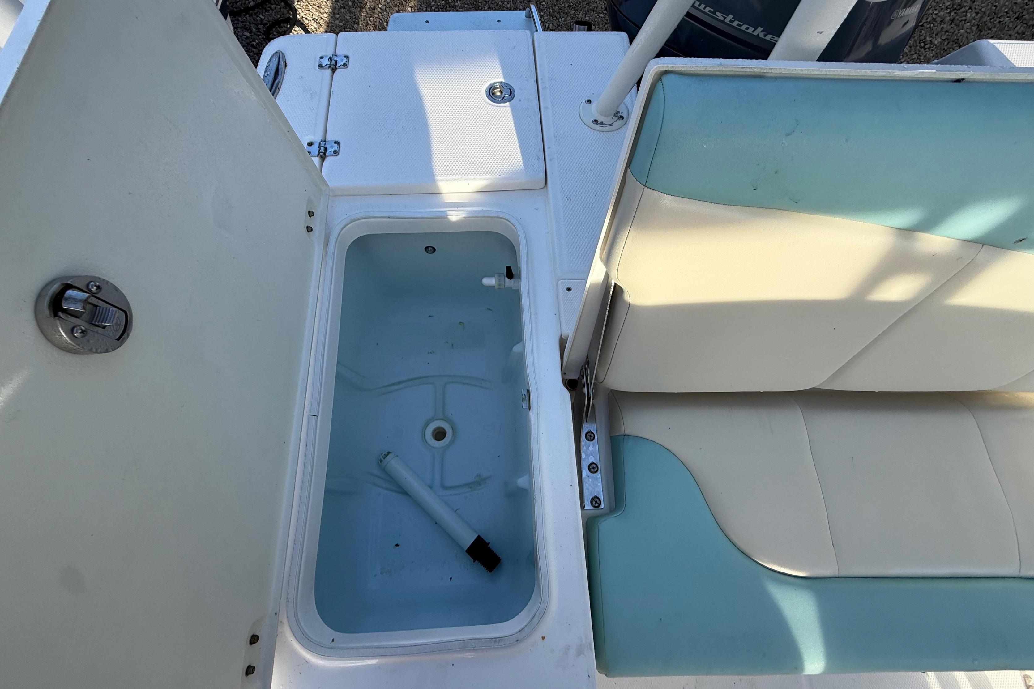 Interior view of a 2017 Robalo 226 Cayman boat with seating and storage.