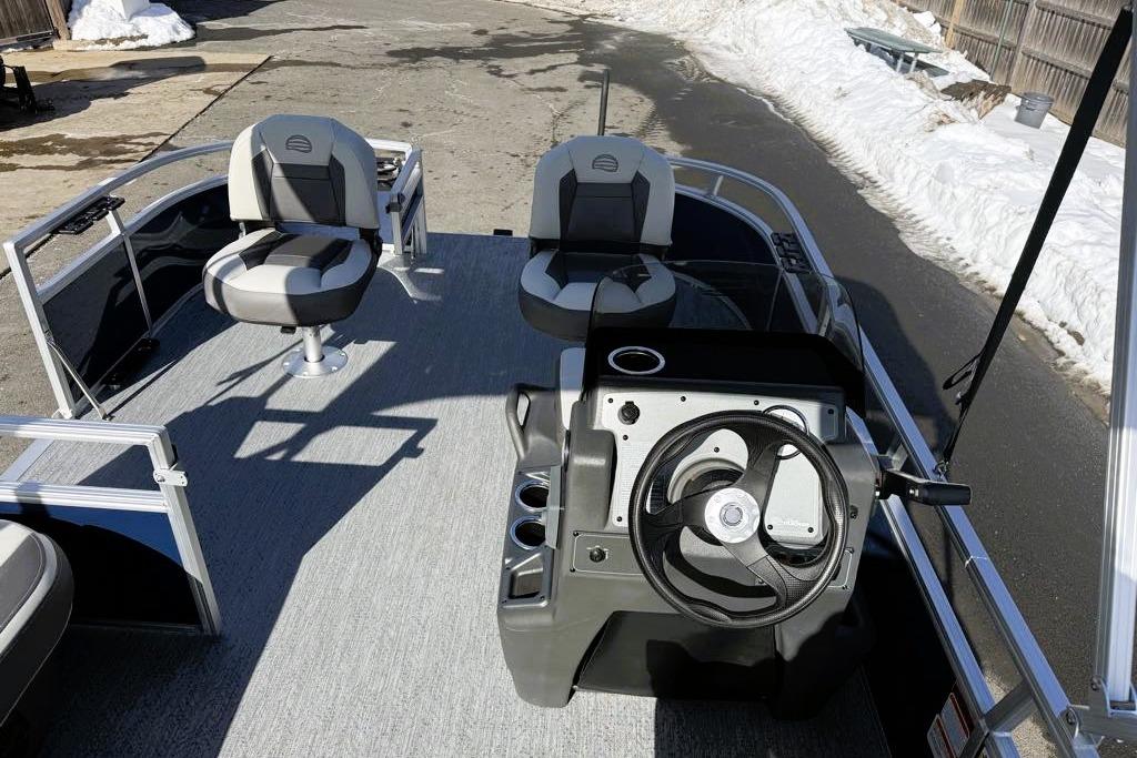 2026 Sun Tracker Bass Buggy 16 XL Select pontoon boat interior with steering console and seating.