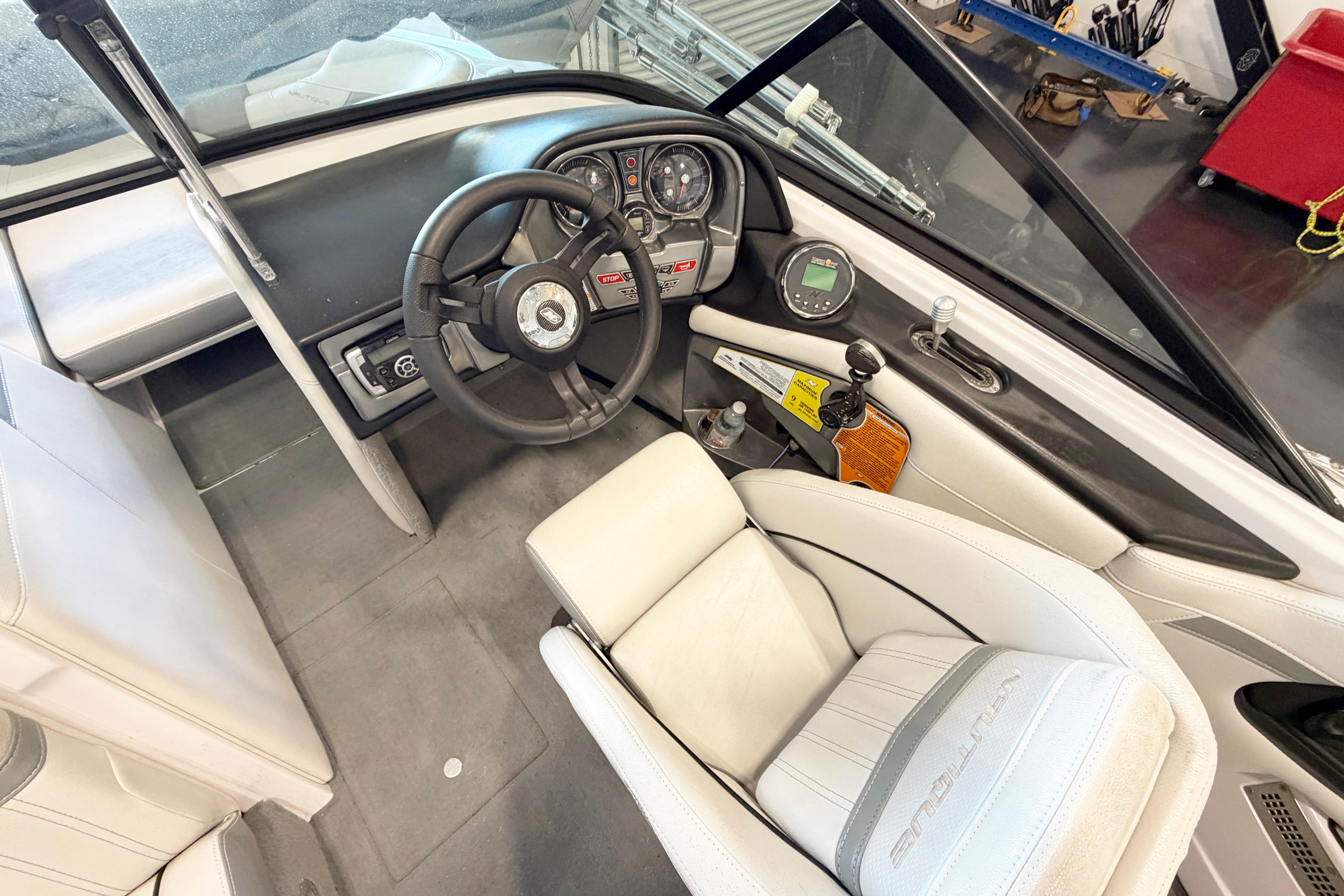 2014 Nautique Ski Nautique 200 Open Bow interior with steering wheel and dashboard controls.