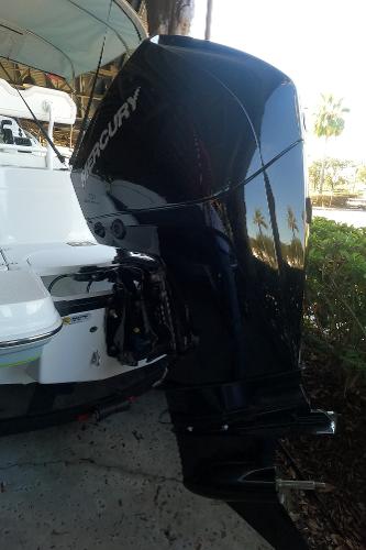 2023 Tahoe 2150 CC boat with Mercury outboard motor, docked outdoors.
