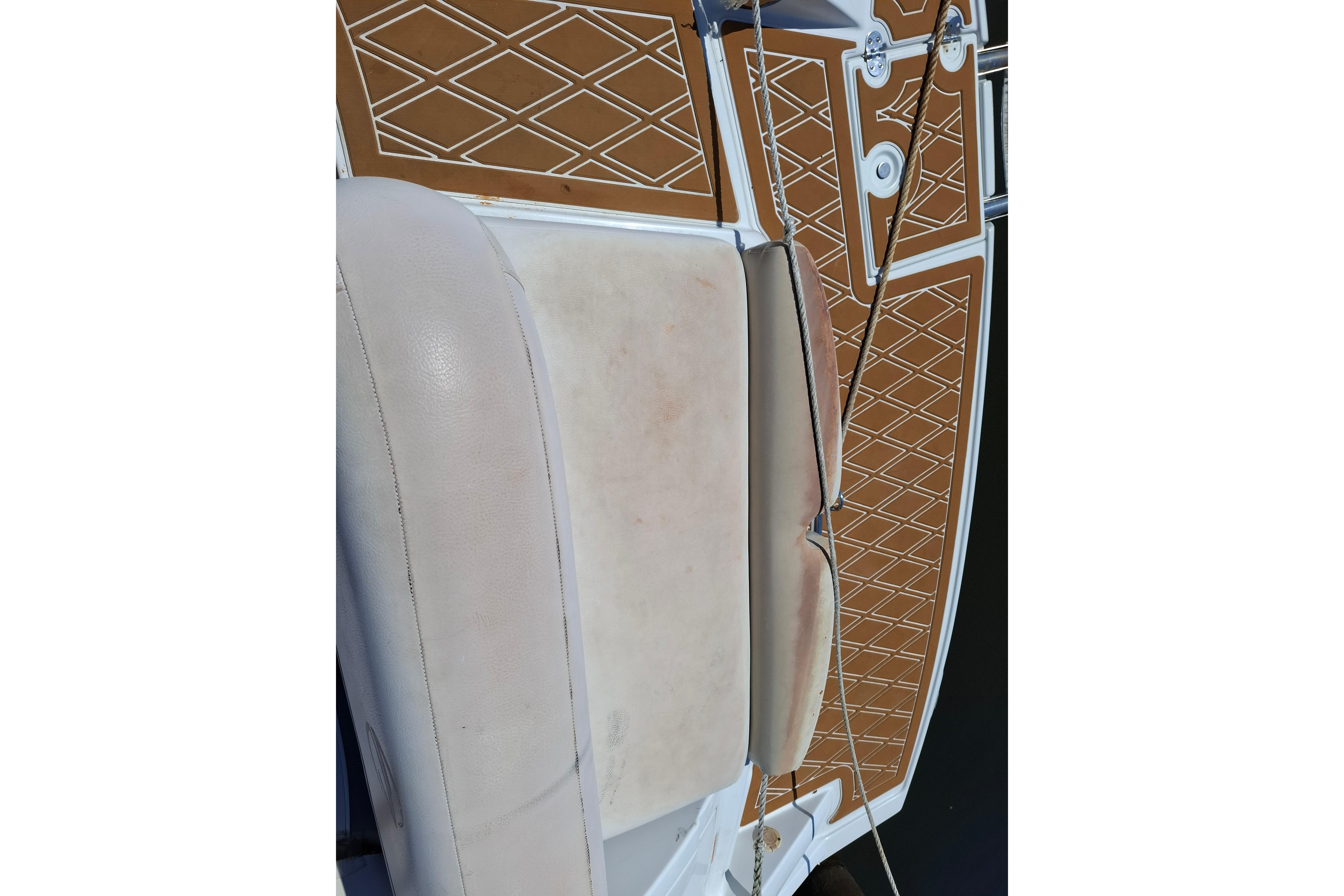 2013 Crownline Eclipse E6 boat interior with tan upholstery and diamond-patterned flooring.
