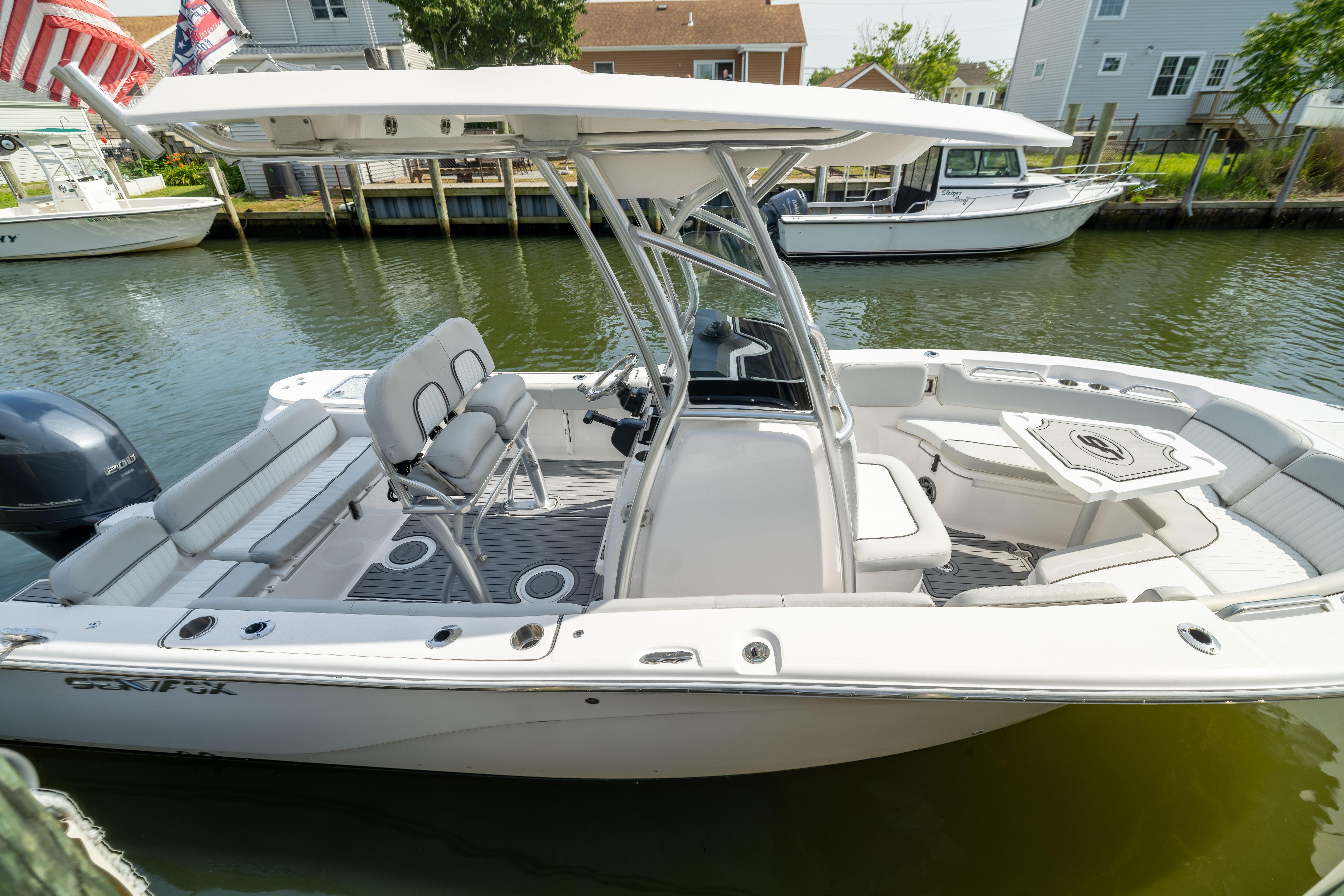 2023 Sea Fox 228 Commander boat docked, featuring spacious seating and modern design.