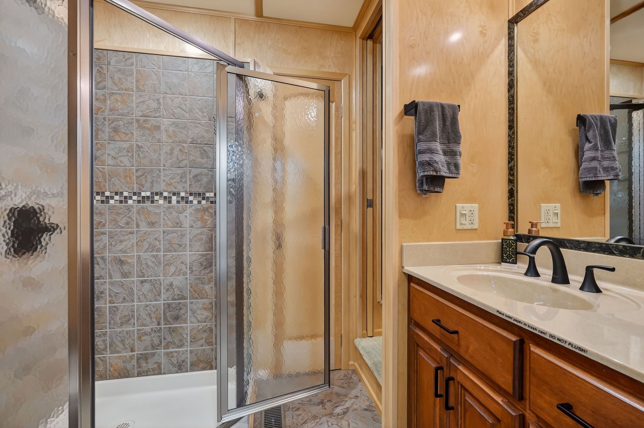 Modern bathroom in a 2010 Houseboat with shower and vanity.