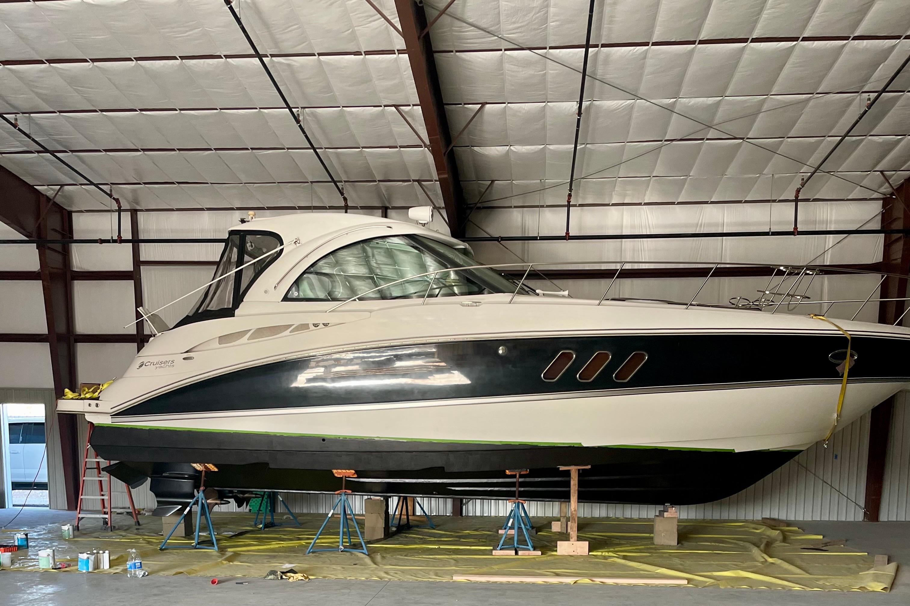 2011 Cruisers Yachts 390 Sports Coupe in a warehouse, elevated on stands.