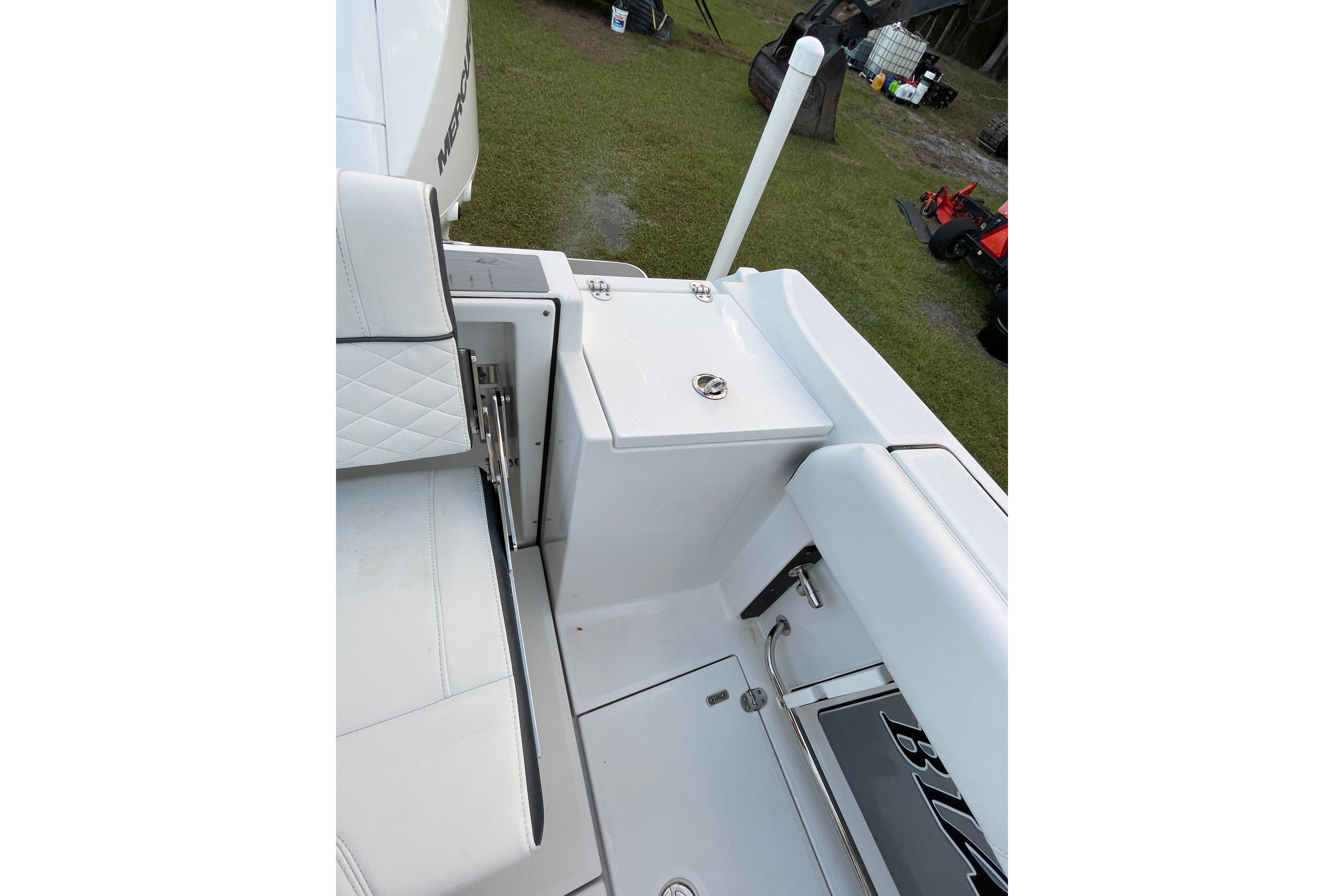2022 Blackfin 252 CC boat interior with white seating and storage compartments.