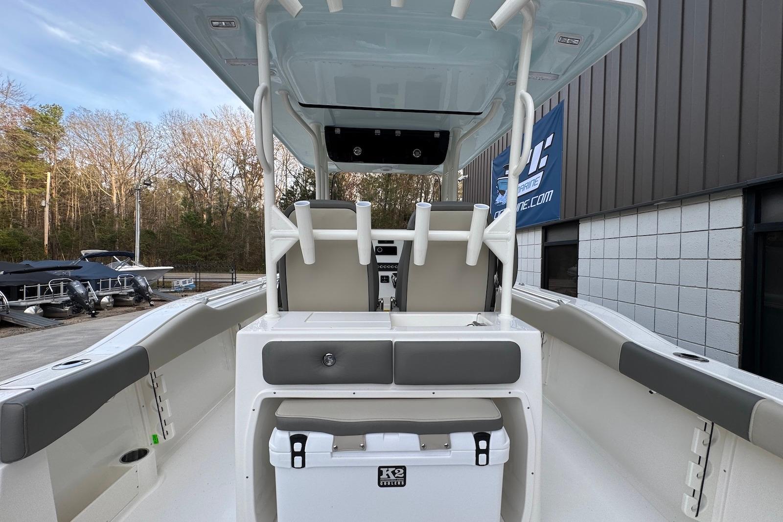 2026 Key West 263 FS boat interior with seating and storage, docked outdoors.