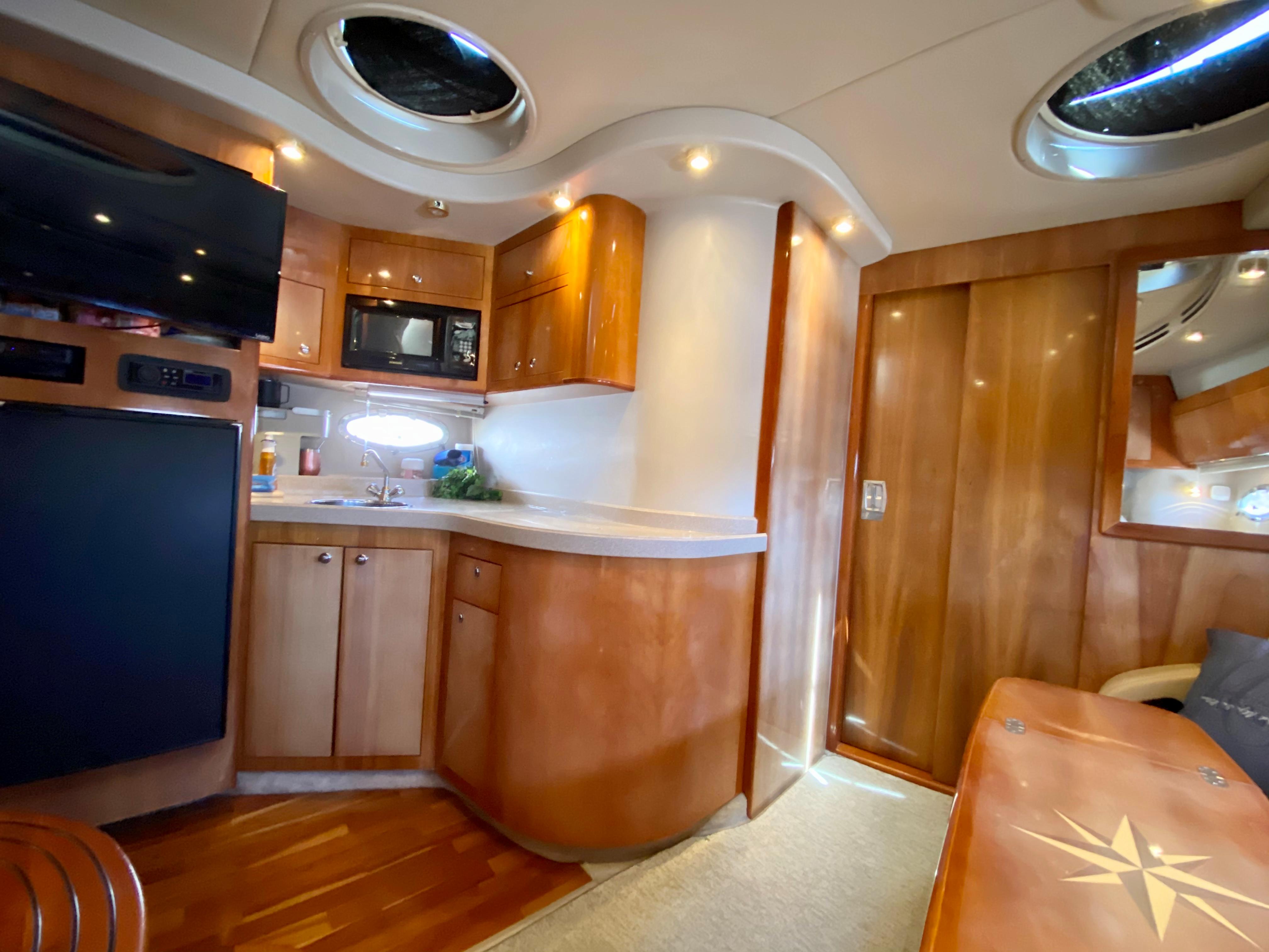 Interior of 2002 Regal 3860 Commodore yacht with modern kitchen amenities.