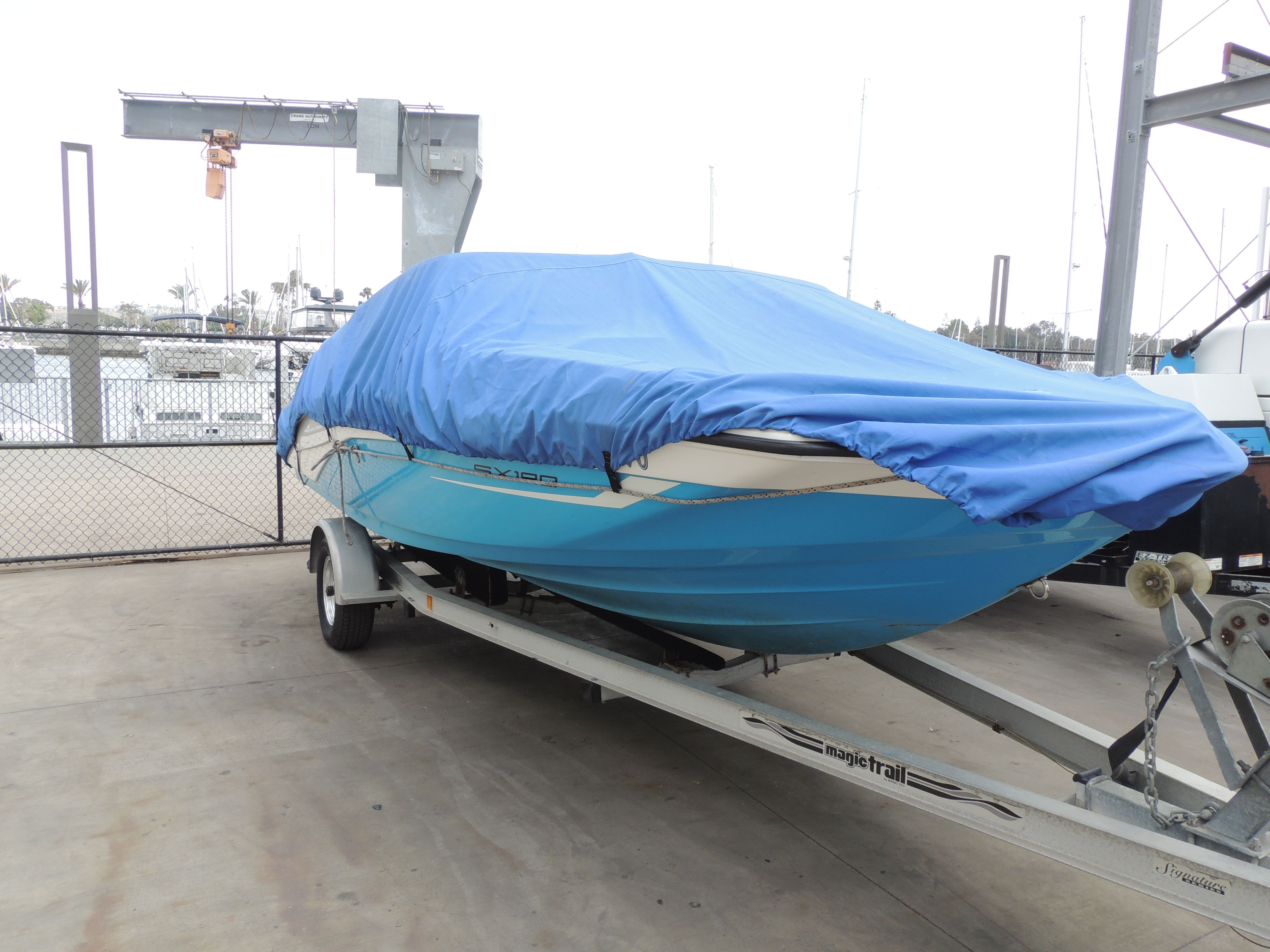 2023 Yamaha SX190 boat on trailer with blue cover.