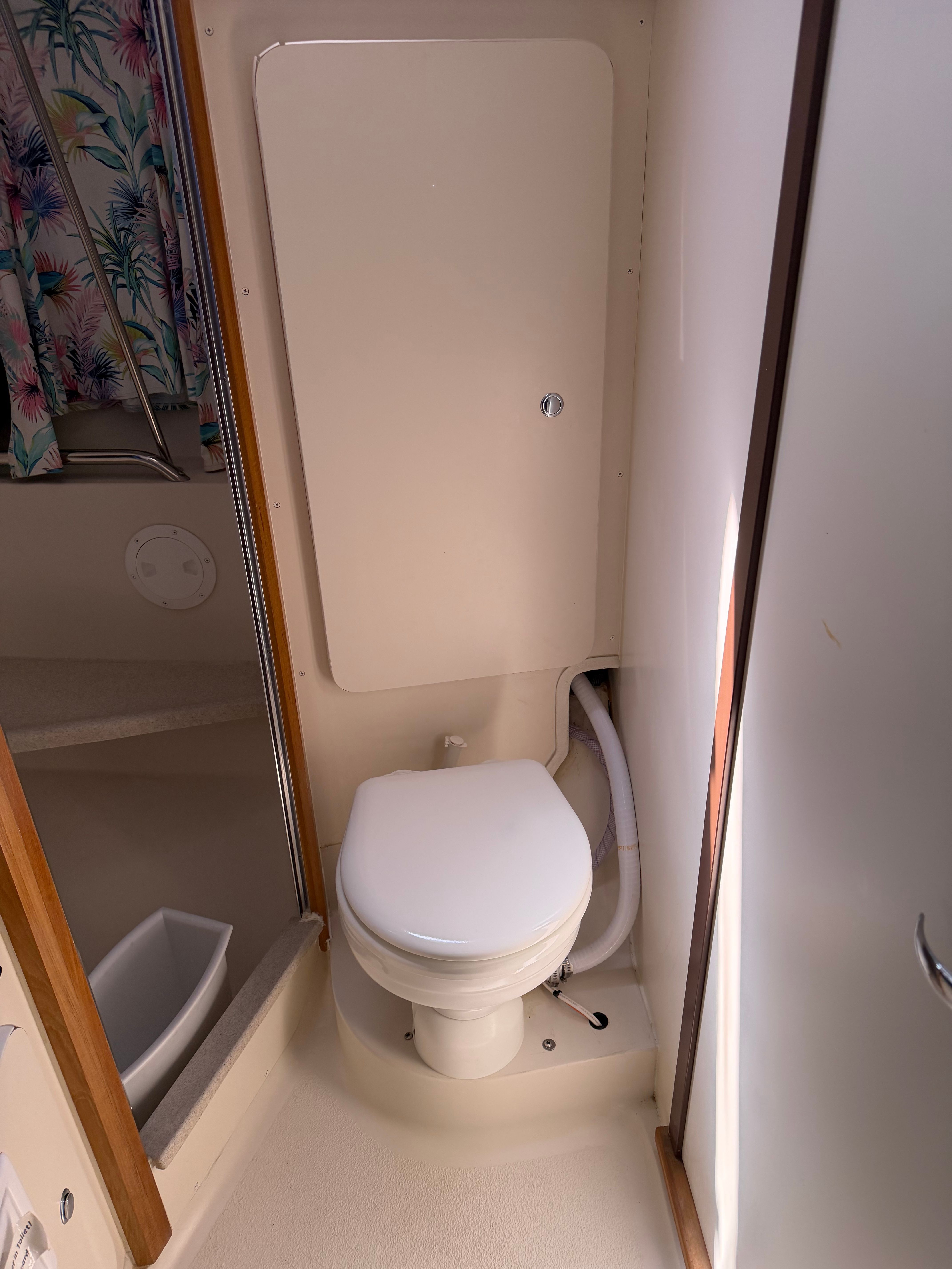 Bathroom of a Catalina 350 yacht with toilet and shower curtain.