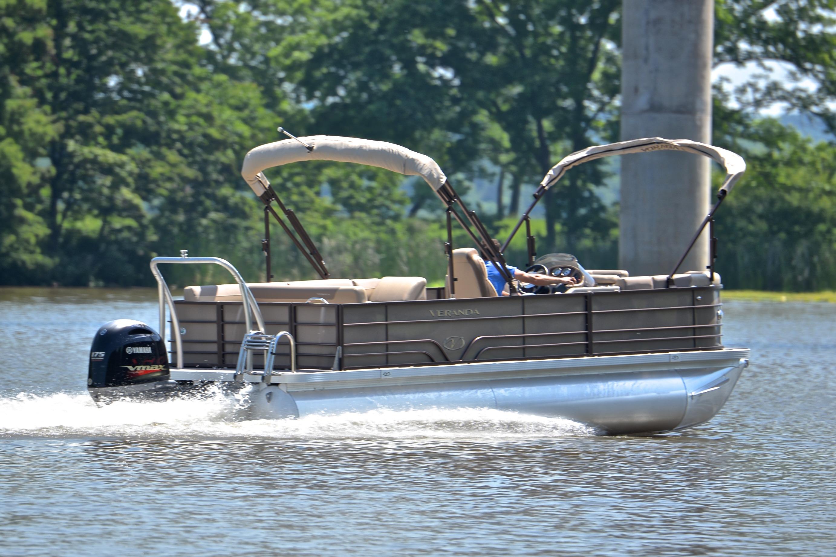 2020 Veranda VR22 pontoon boat cruising on a lake with trees in the background.