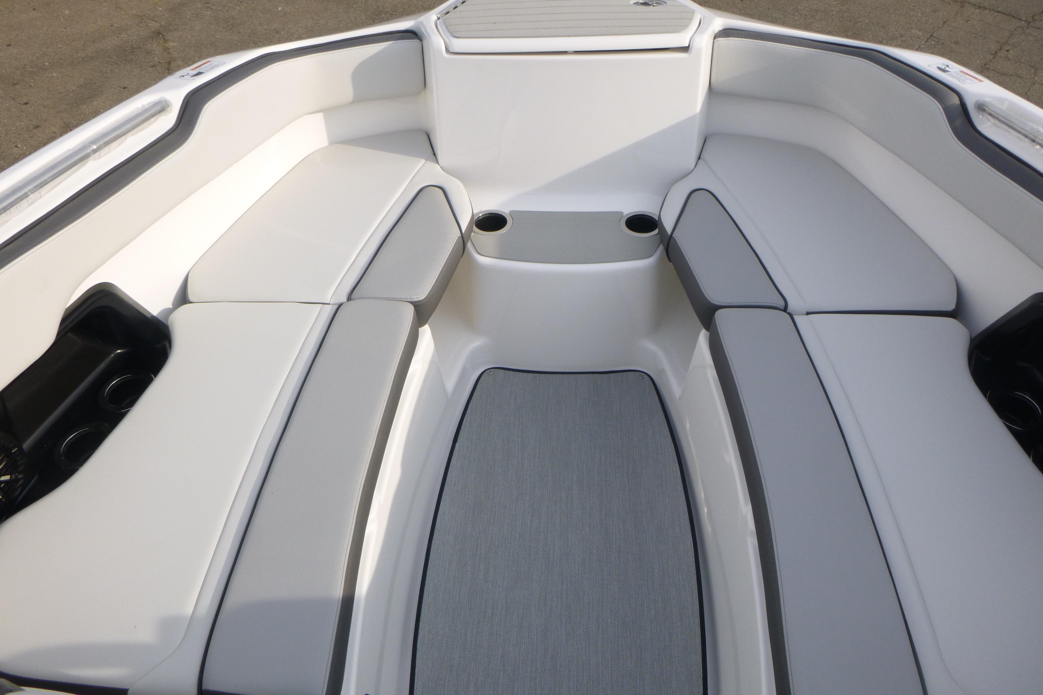 2026 Yamaha Boats AR250 interior with cushioned seating and cup holders.