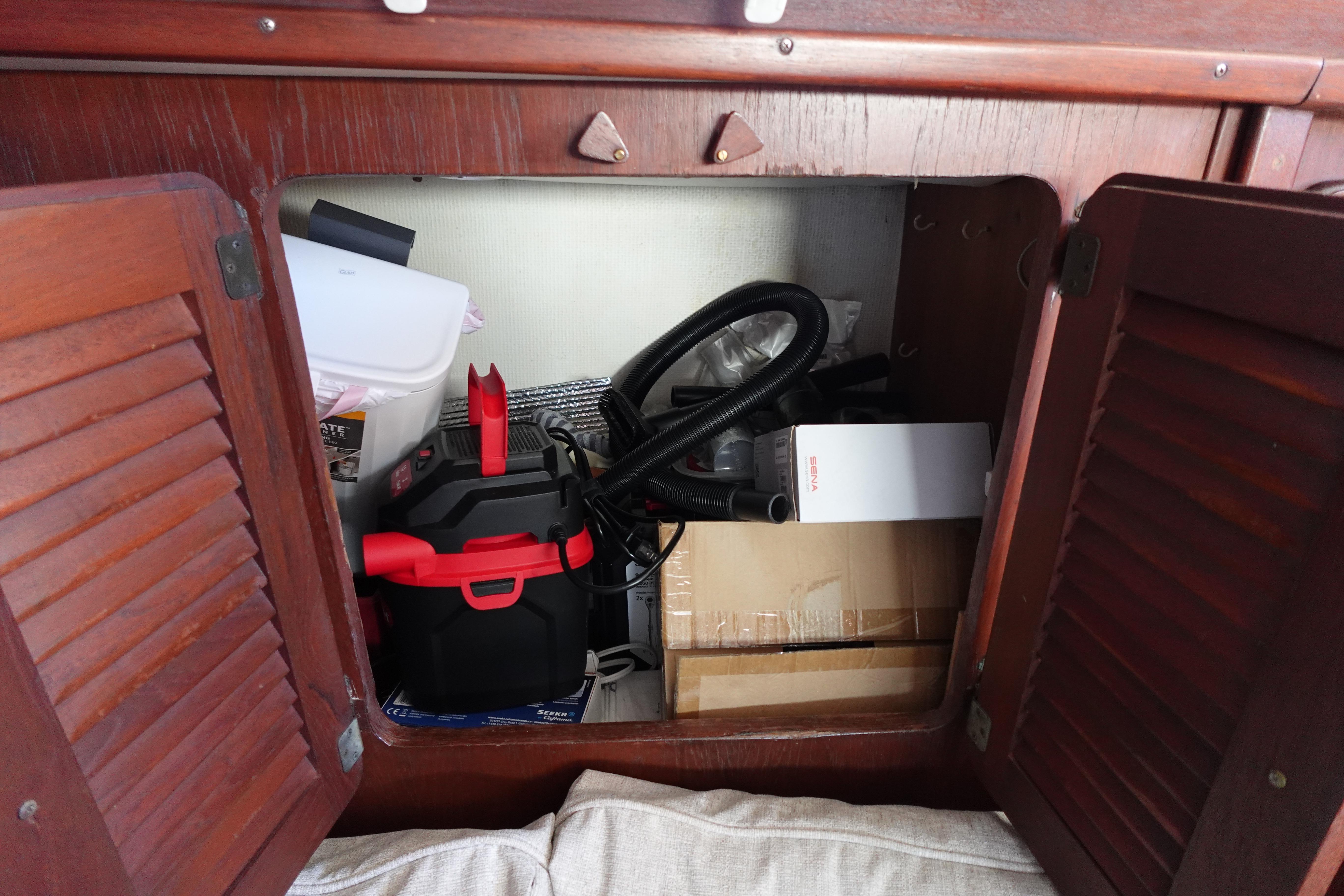 Storage compartment in a 1978 Morgan 382 sailboat with various equipment and supplies.
