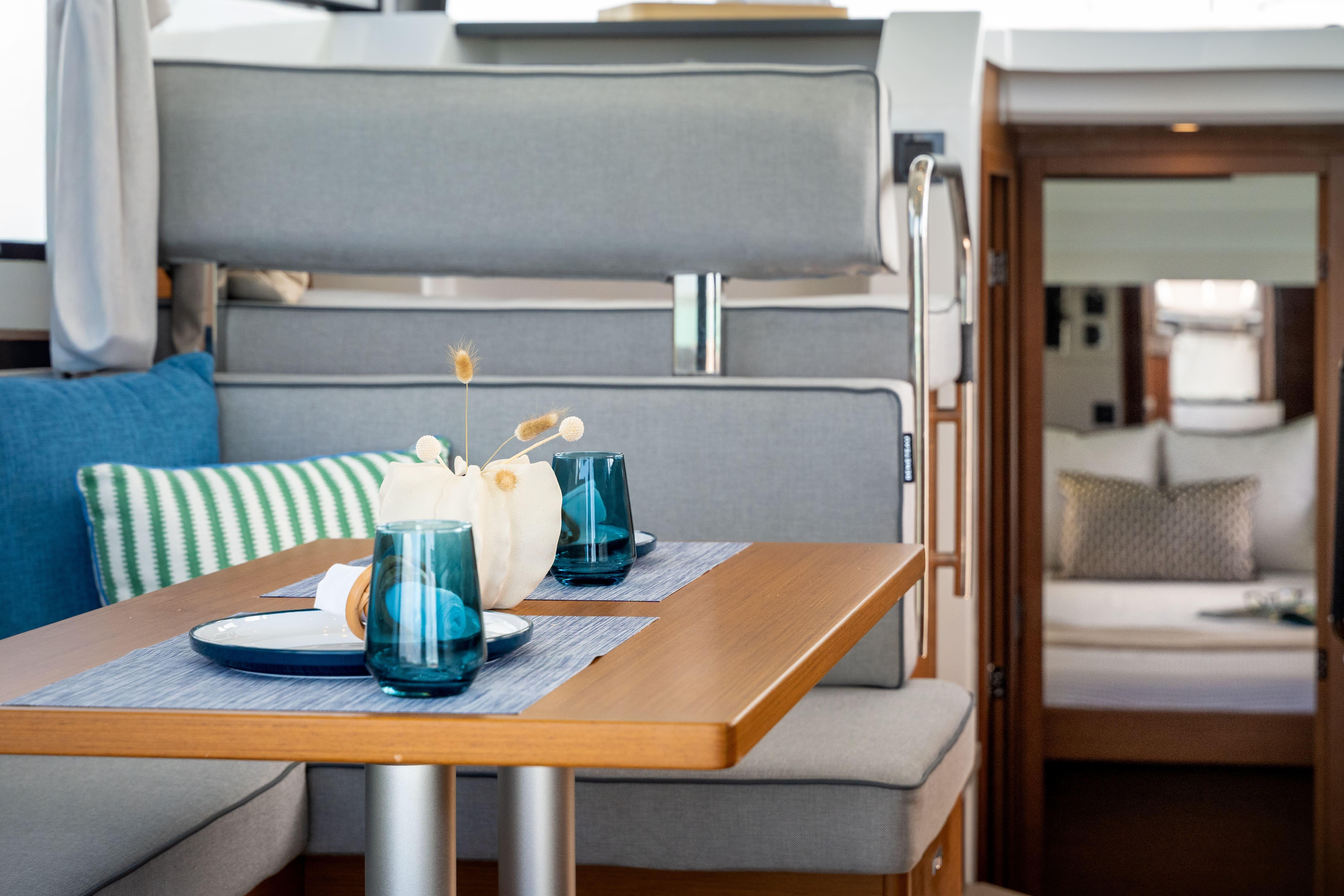 Interior of 2026 Beneteau Swift Trawler 37 Fly, featuring elegant dining area with blue accents.