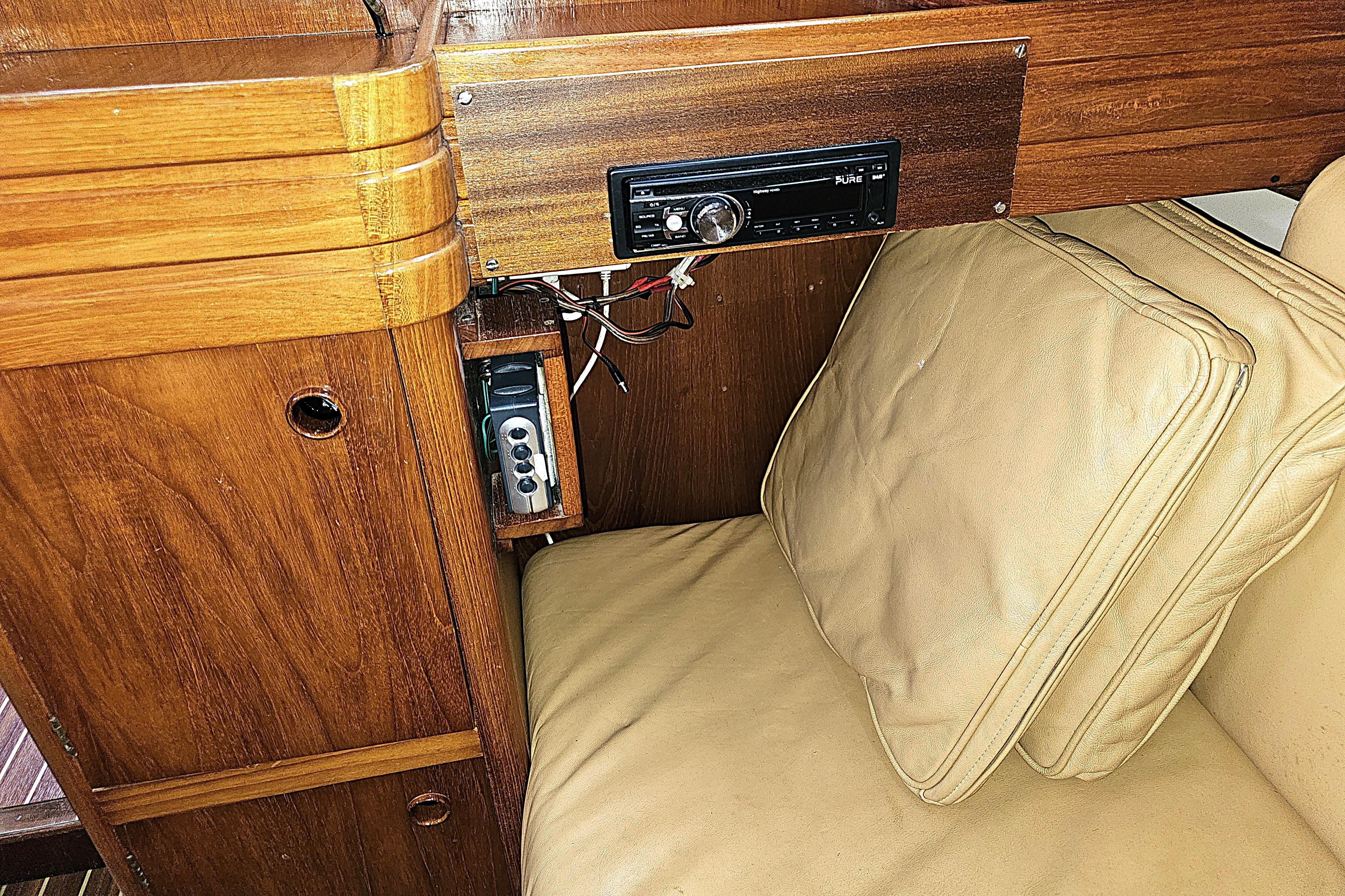 Interior of 1992 Northshore Yachts Vancouver 34 with wooden paneling and beige cushions.