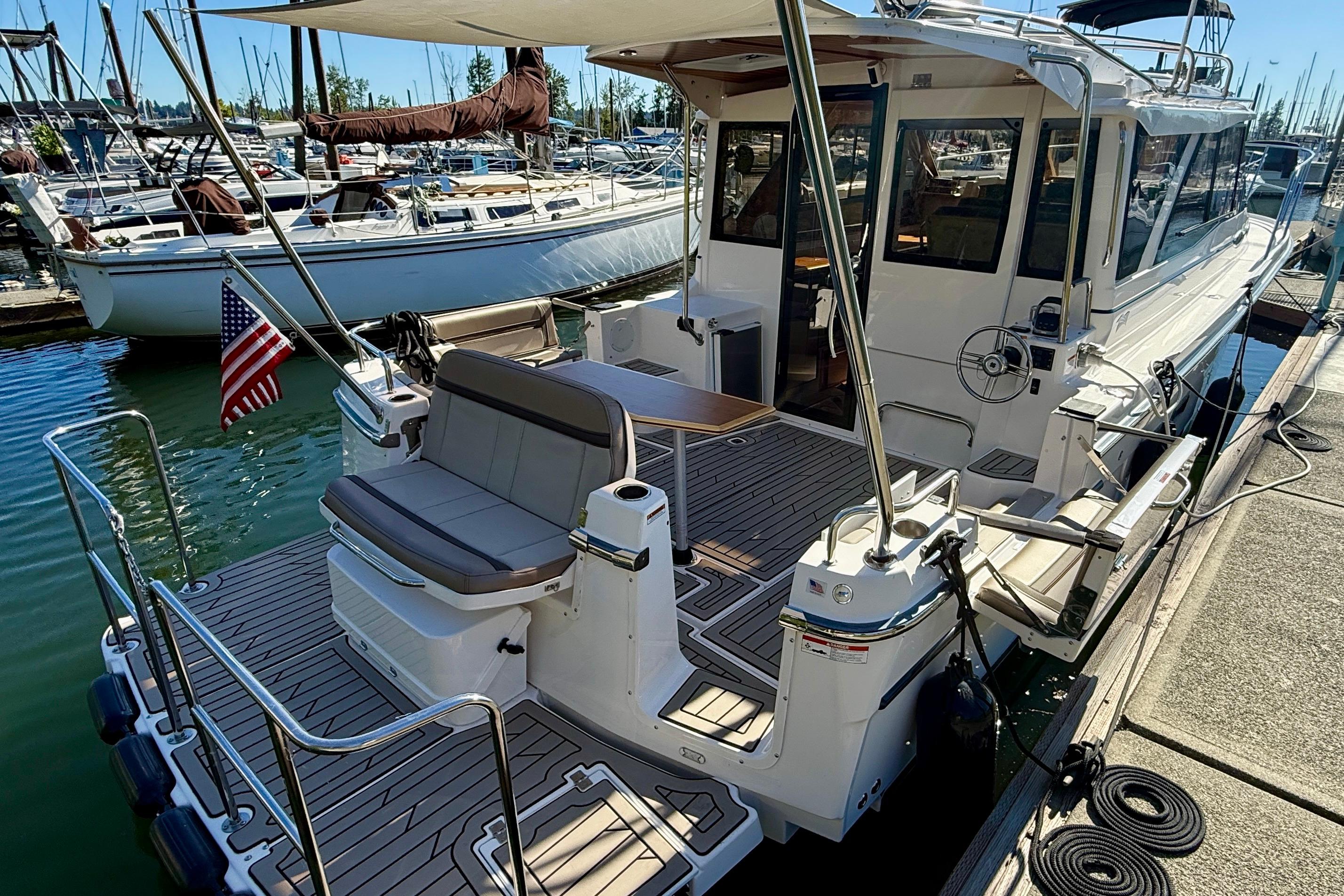 2023 Cutwater C-30 Sedan docked, featuring spacious deck and seating area.