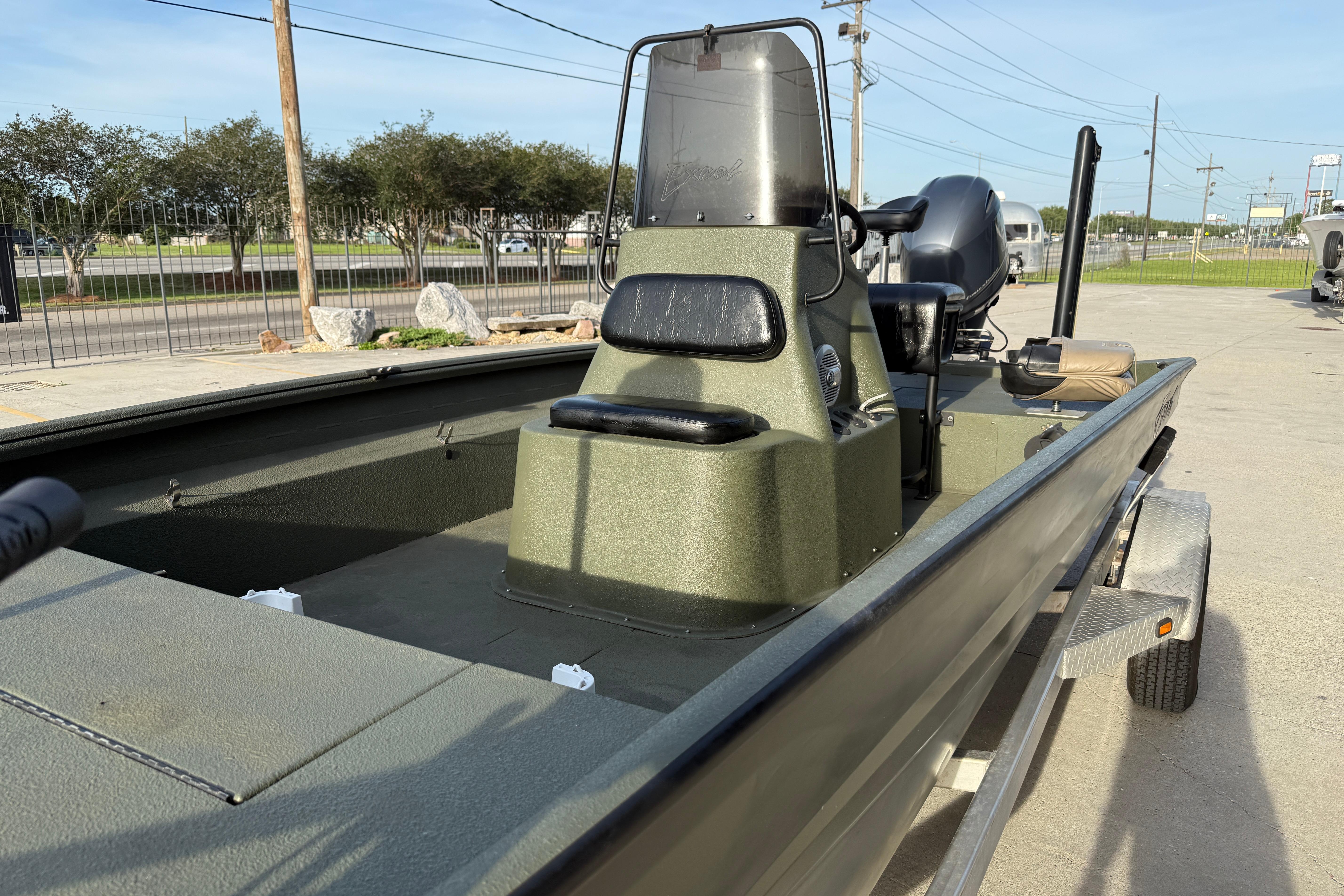 2014 Excel 203 Bay Pro boat on trailer, parked outdoors.