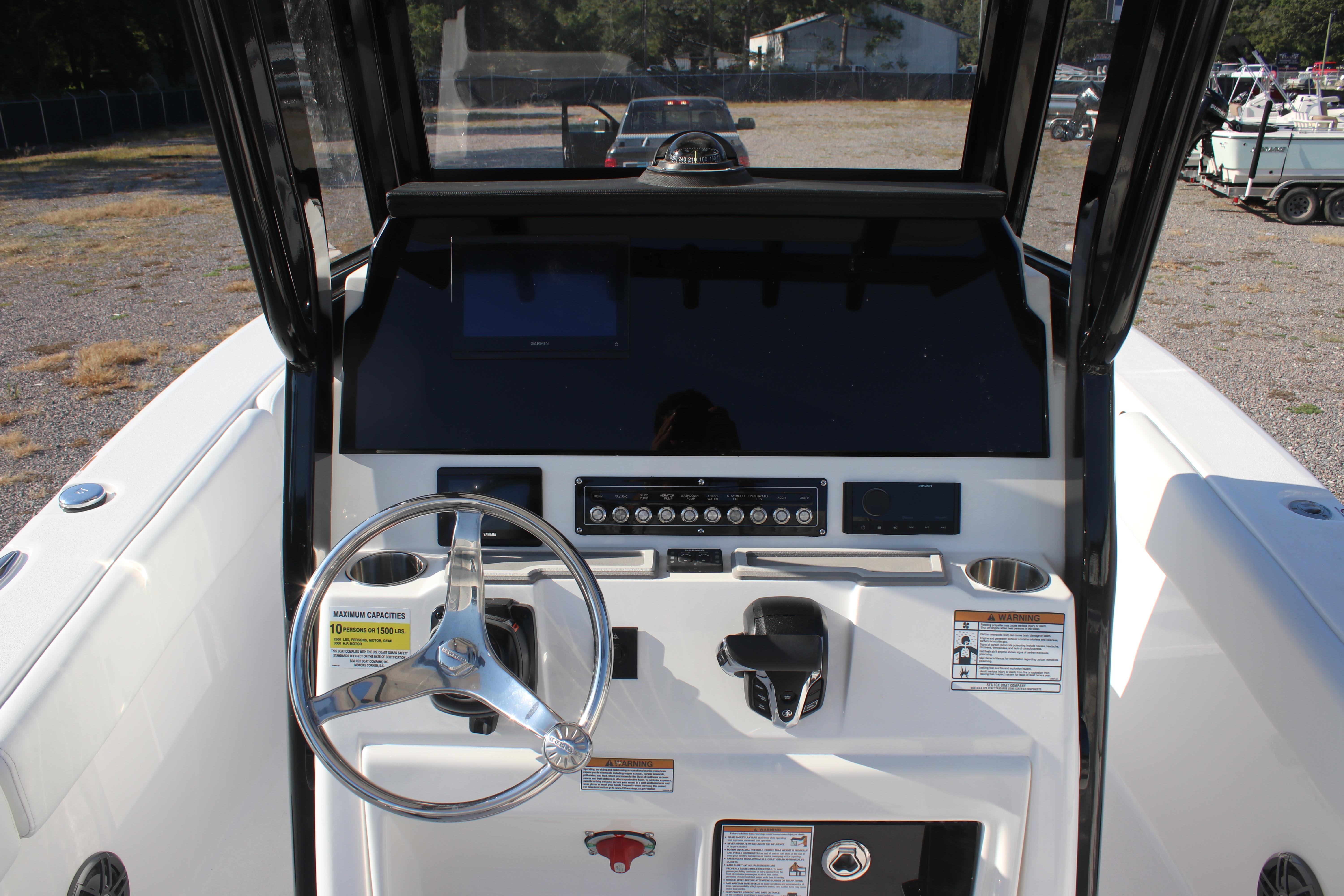 2026 Sea Fox 248 Commander boat dashboard with steering wheel and control panel.