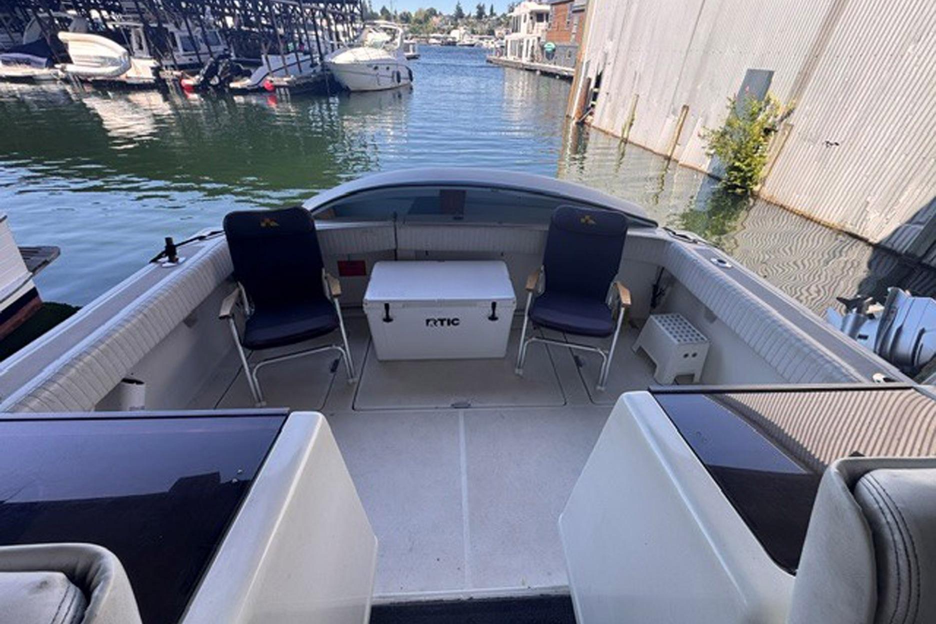 1988 Tiara Yachts 3300 Open boat interior with seating and cooler, docked at marina.