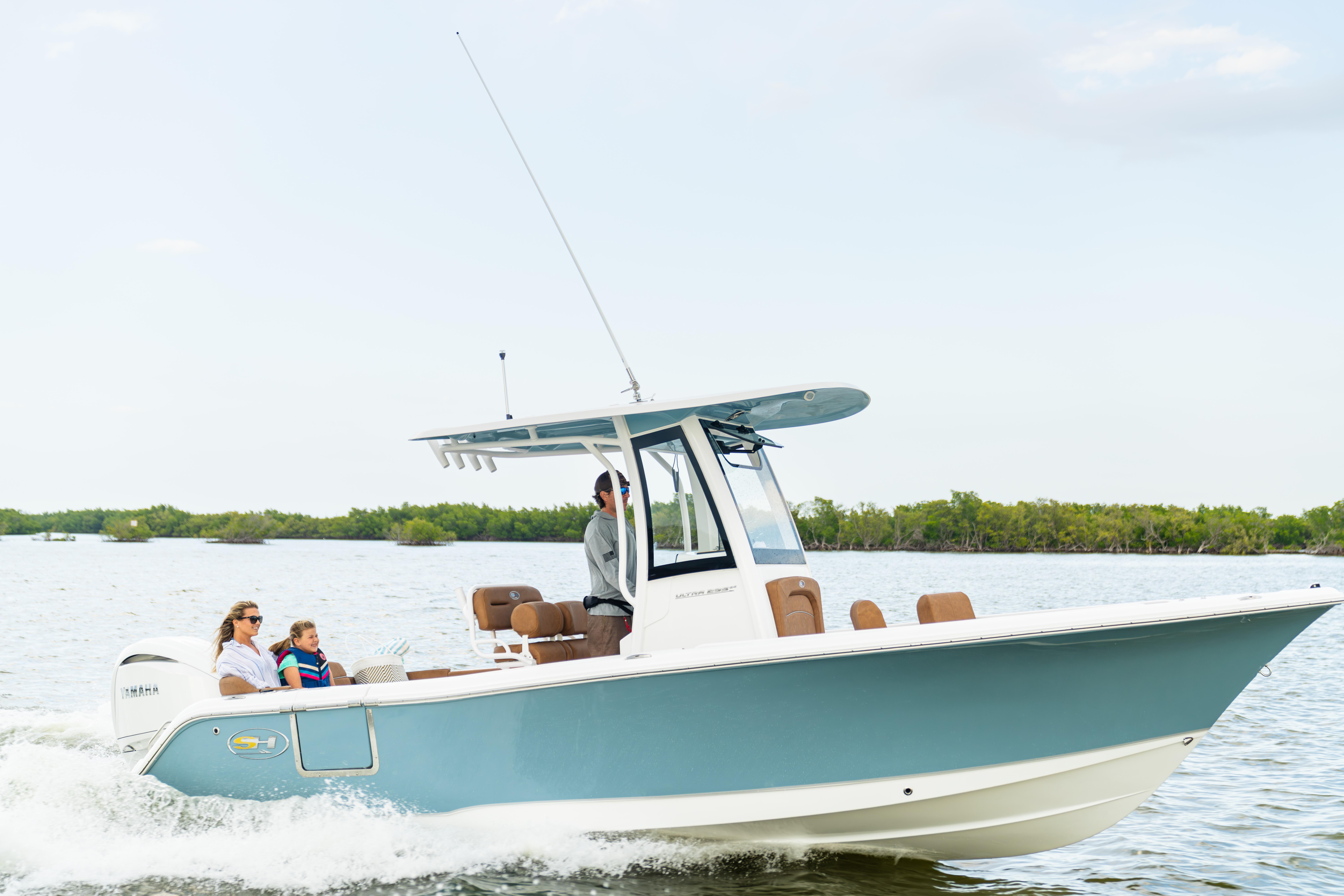 2026 Sea Hunt Ultra 235 SE boat cruising on water with passengers enjoying the ride.
