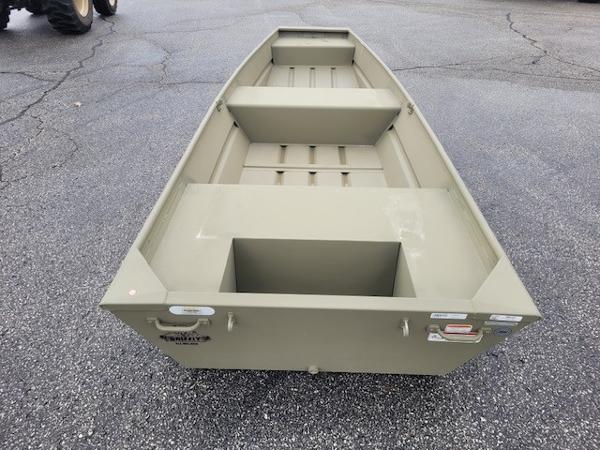 2025 Tracker Grizzly 1436 Utility boat on asphalt surface.