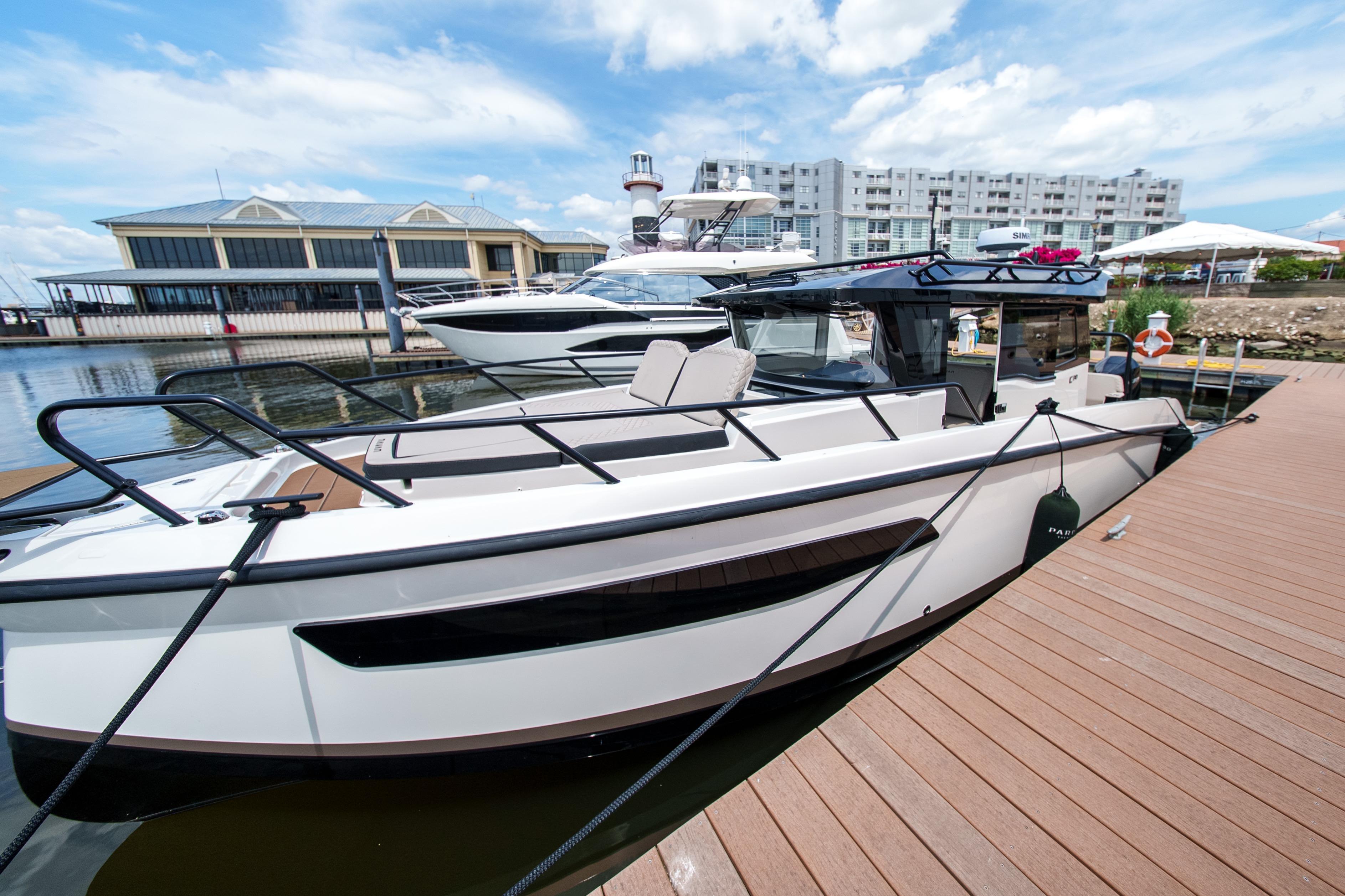 2026 Navan C30 boat docked at marina, modern design, clear sky background.