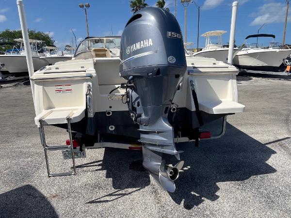 2018 Scout 210 Dorado boat with Yamaha 150 outboard motor, parked on a sunny day.