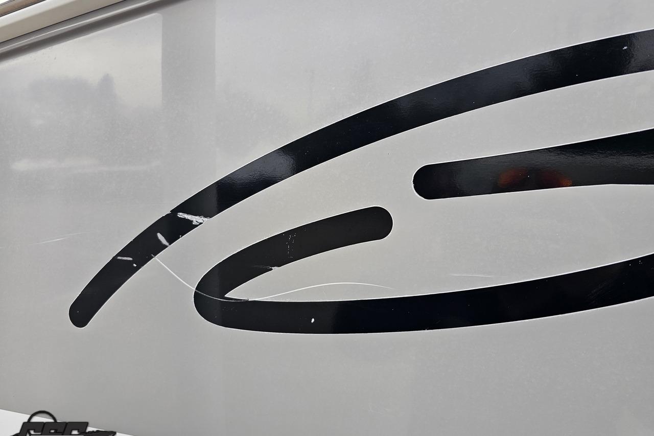 Close-up of 2008 Baja 335 Performance boat with black graphic design.