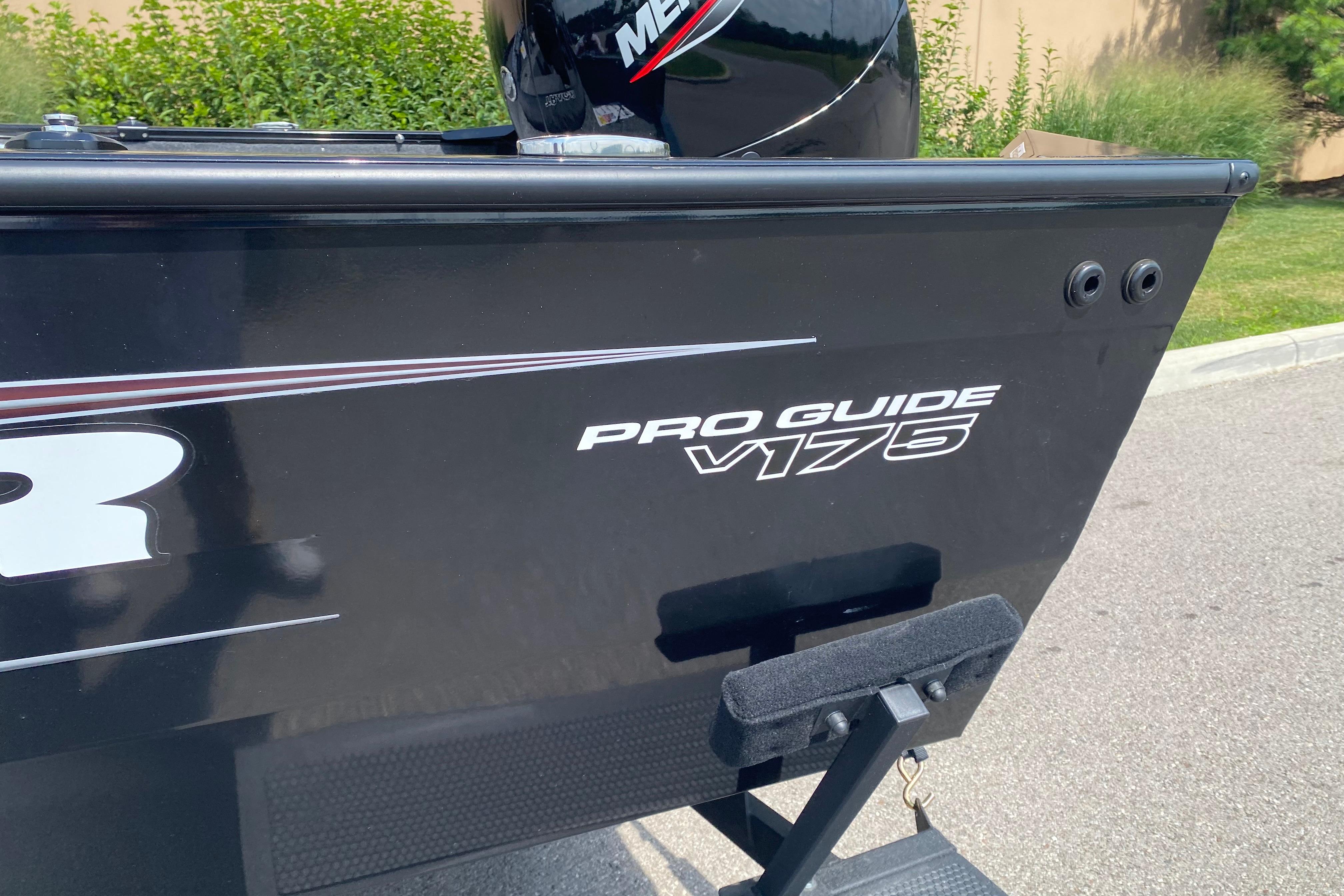 2026 Tracker Pro Guide V-175 Combo boat, black exterior, parked outdoors.