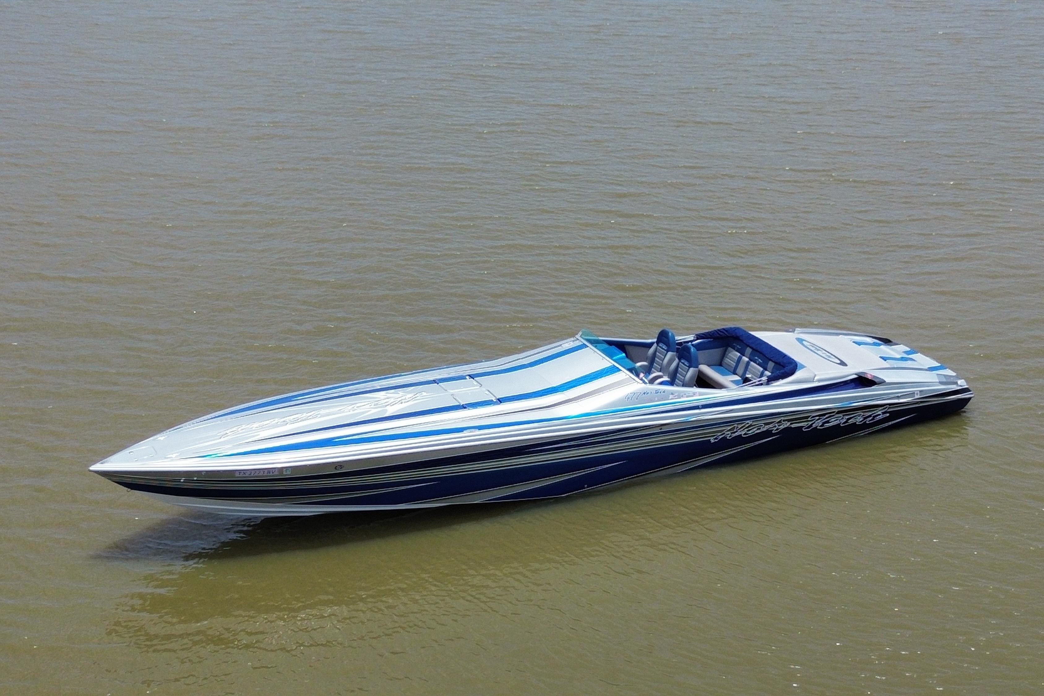 2013 Nor-Tech 477 SPX Vee Bottom boat on calm water, featuring sleek blue and white design.
