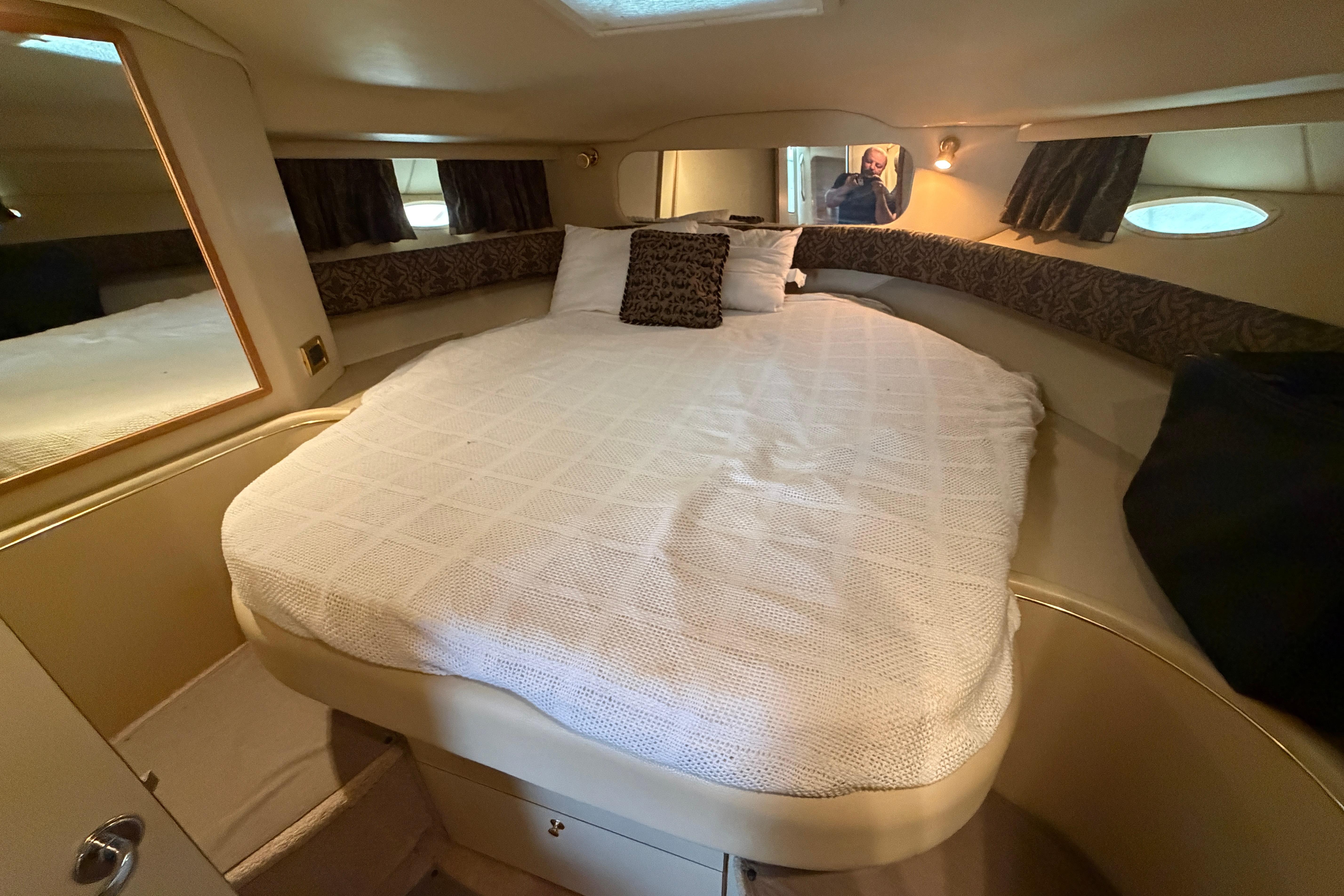 1999 Sea Ray 400 Sundancer cabin with cozy bed and elegant interior design.