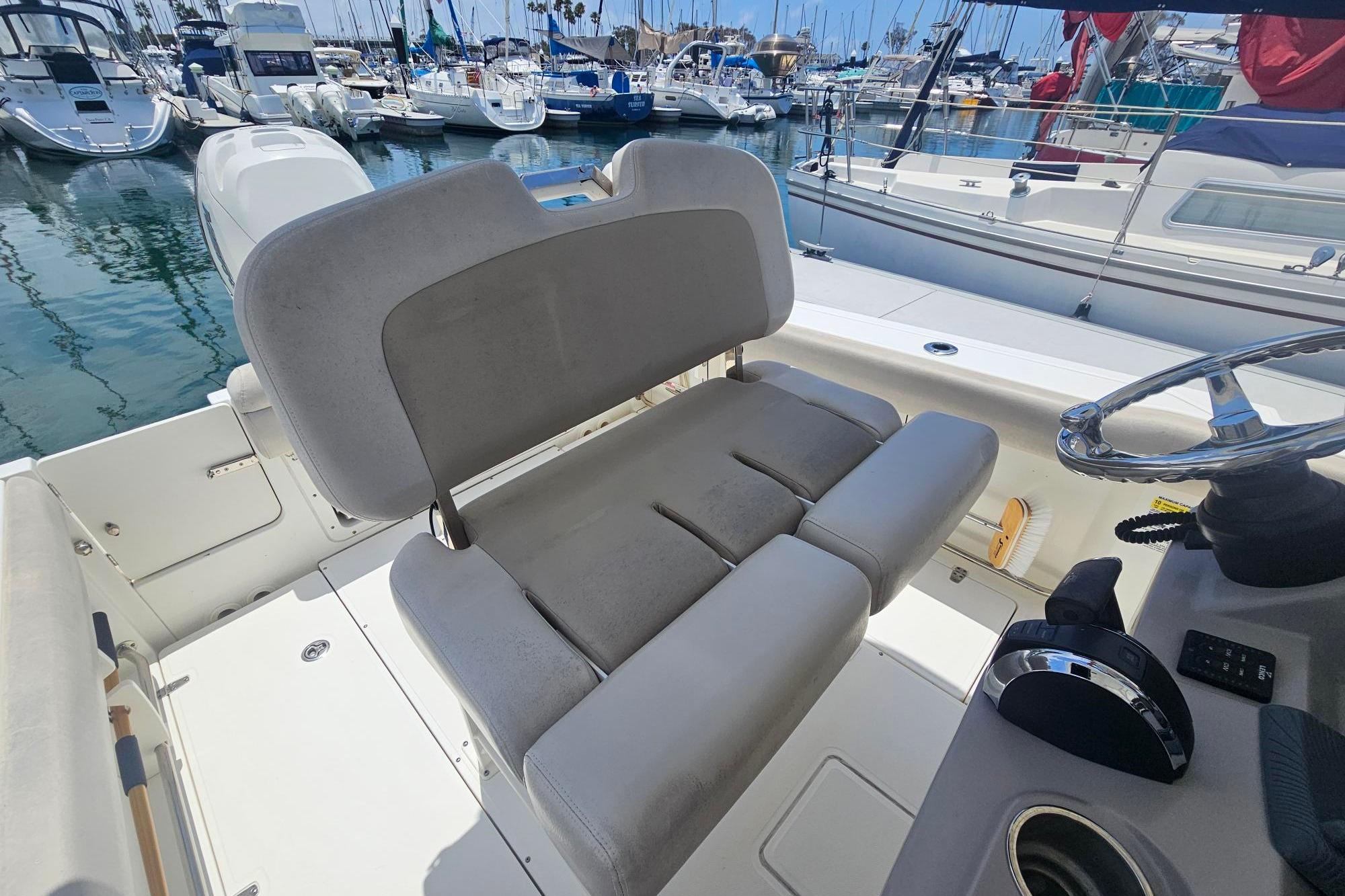 2017 Boston Whaler 230 Outrage boat interior with helm seat and steering wheel.